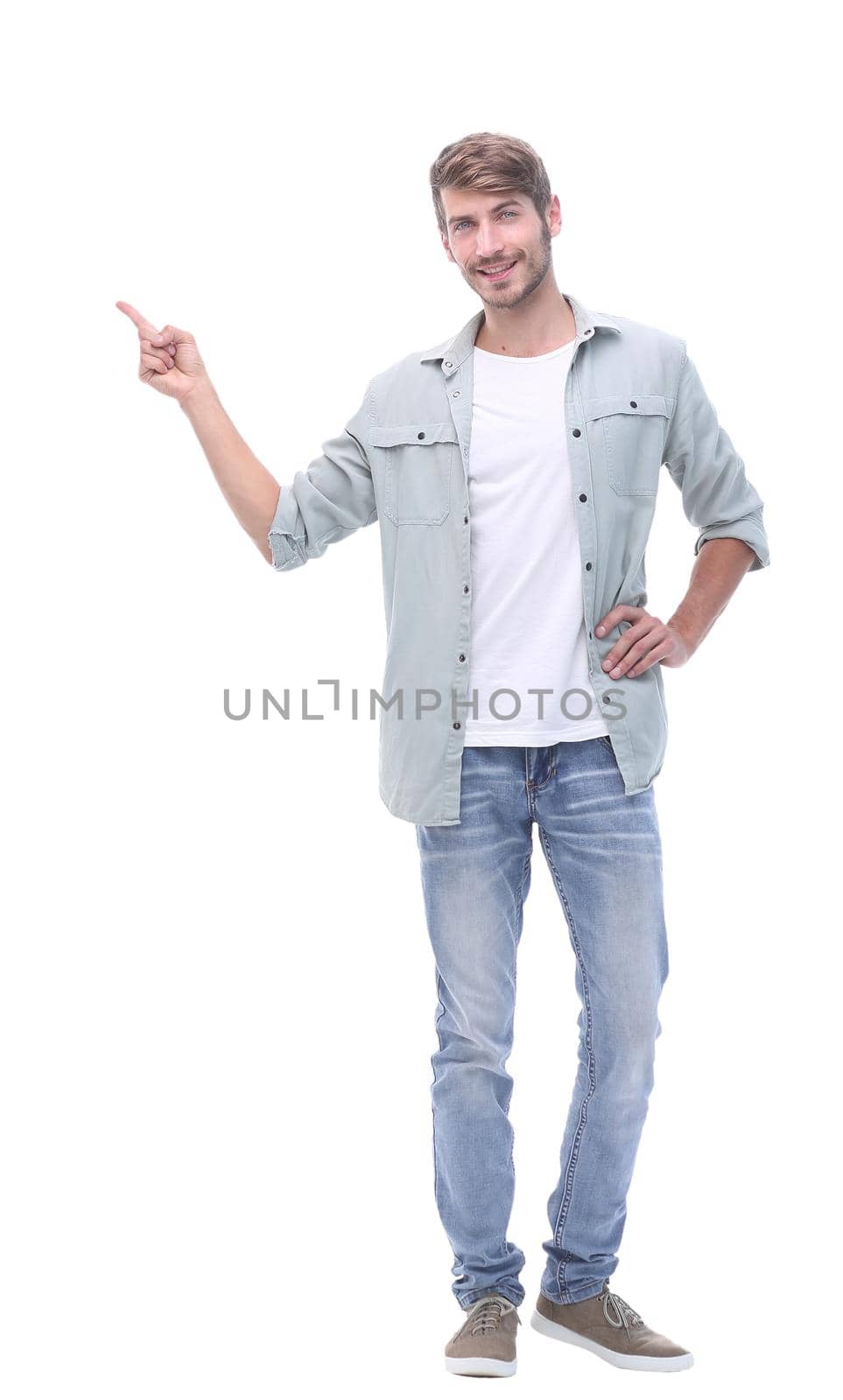 in full growth. successful young man showing on copy space.photo with text place