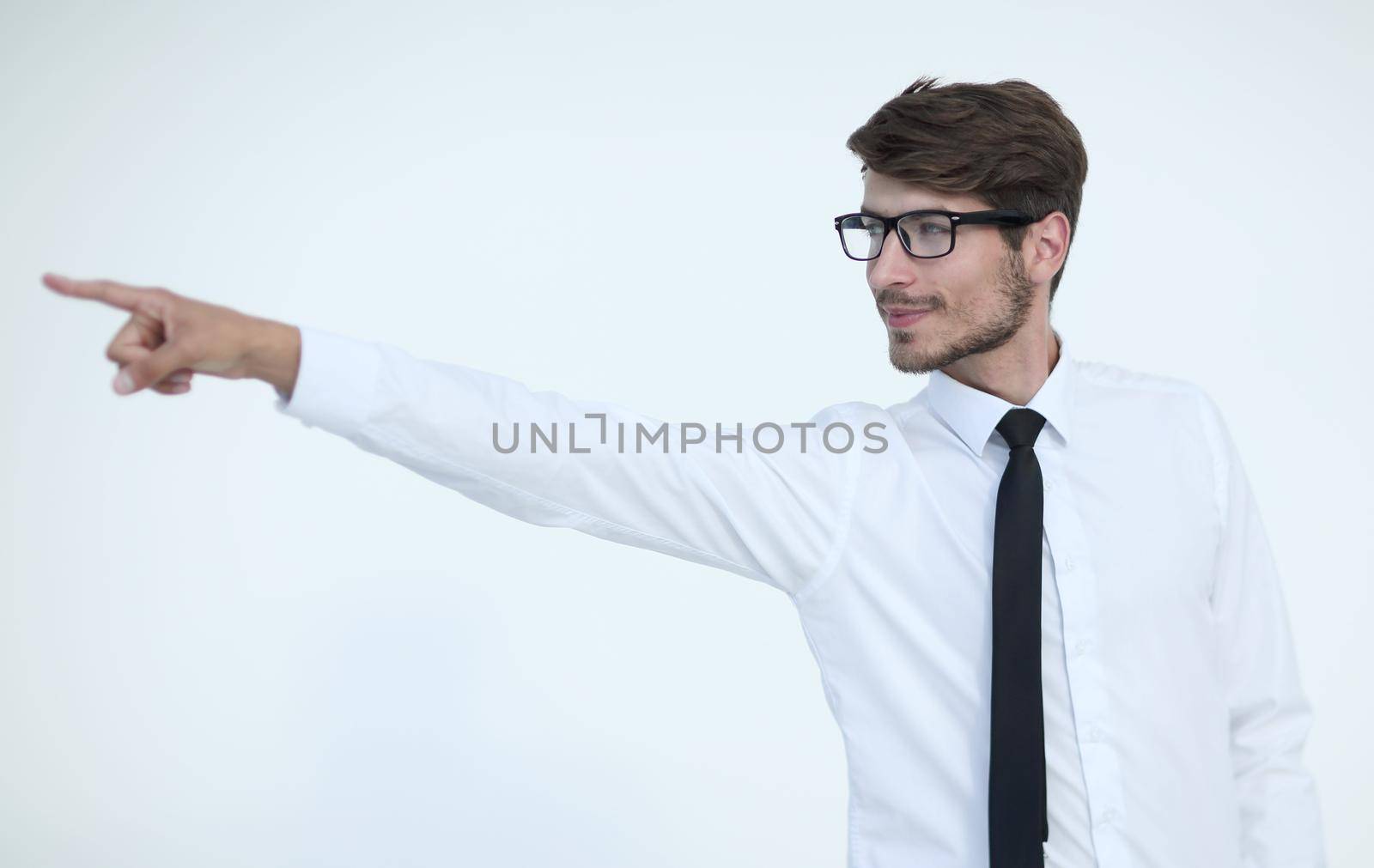 Young businessman with glasses points his finger to the side while in office