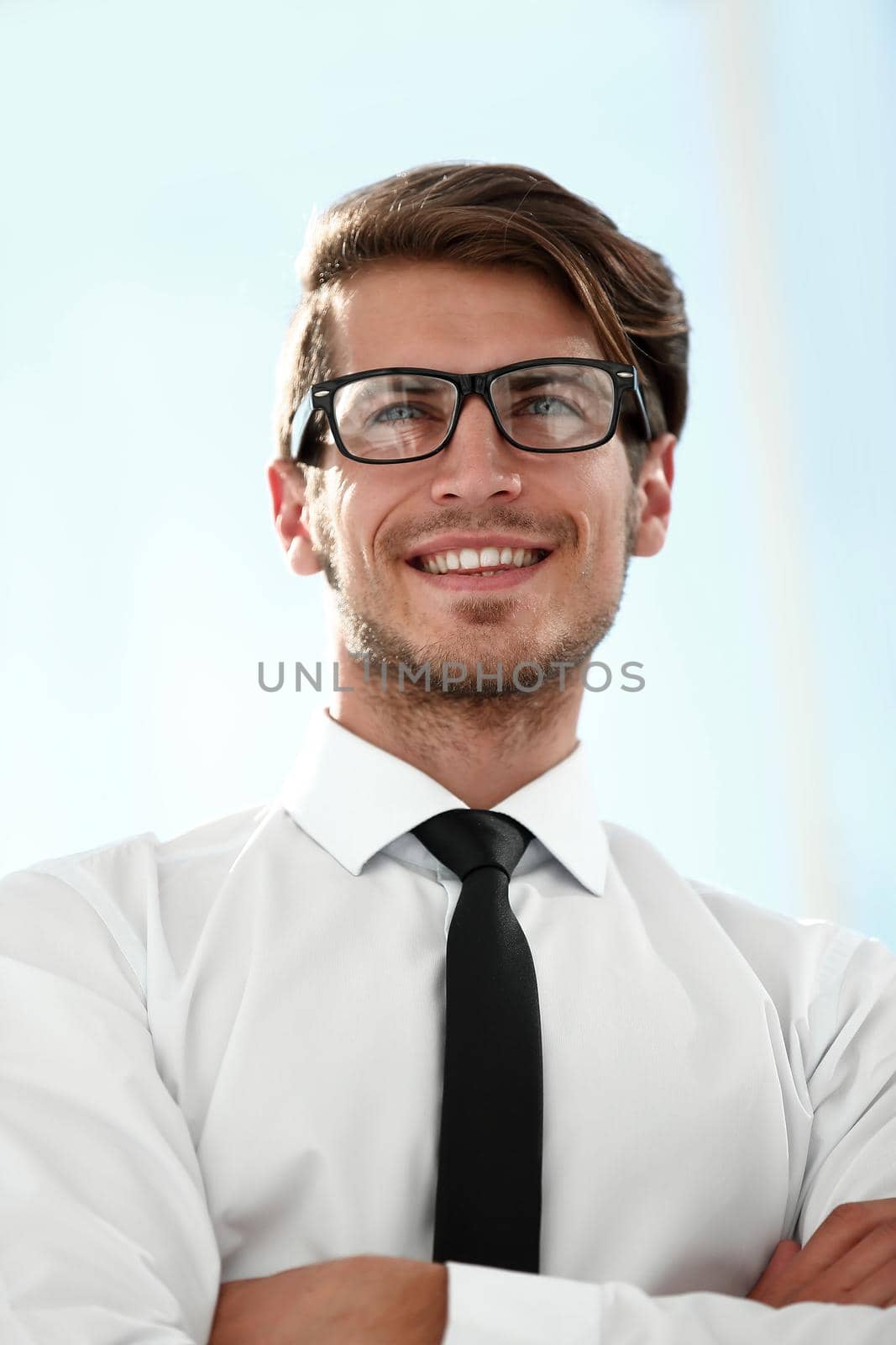 close up.confident businessman standing near the office window.business people