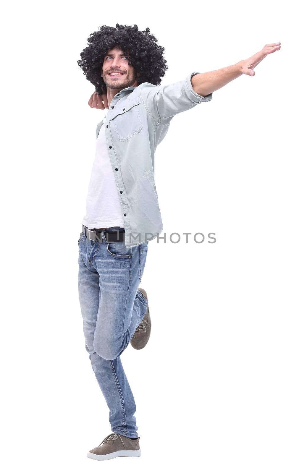 in full growth. stylish young man pointing to copy space .isolated on white background