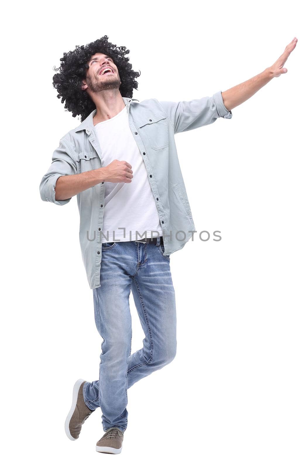 in full growth. stylish young man pointing to copy space .isolated on white background