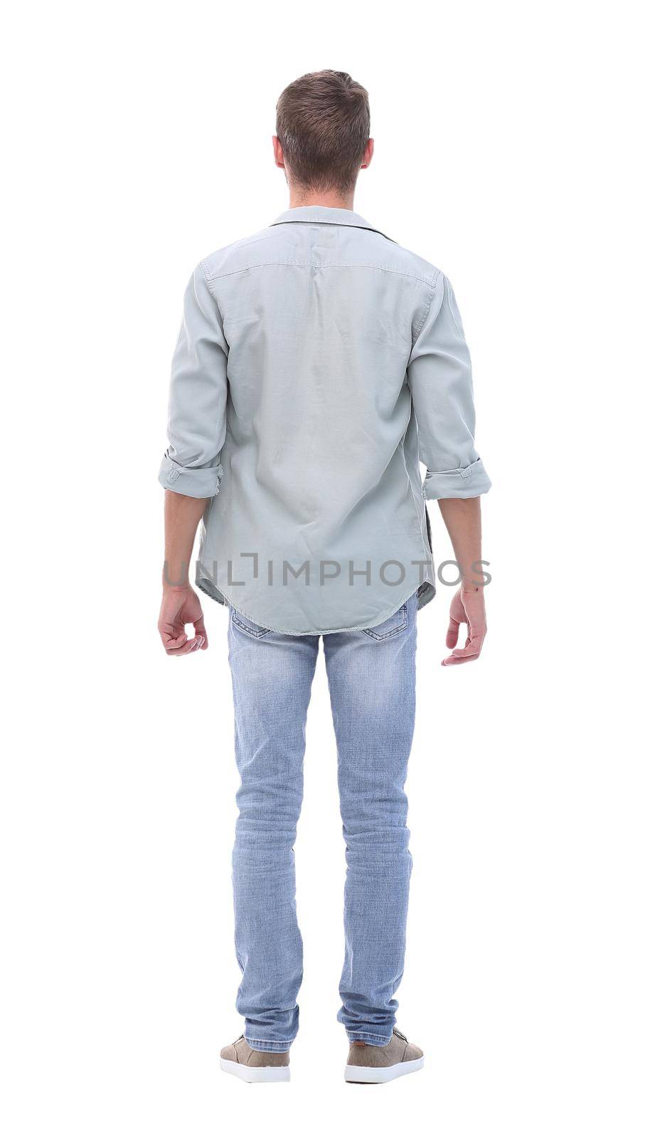 rear view. young man in jeans looking at copy space.isolated on white background