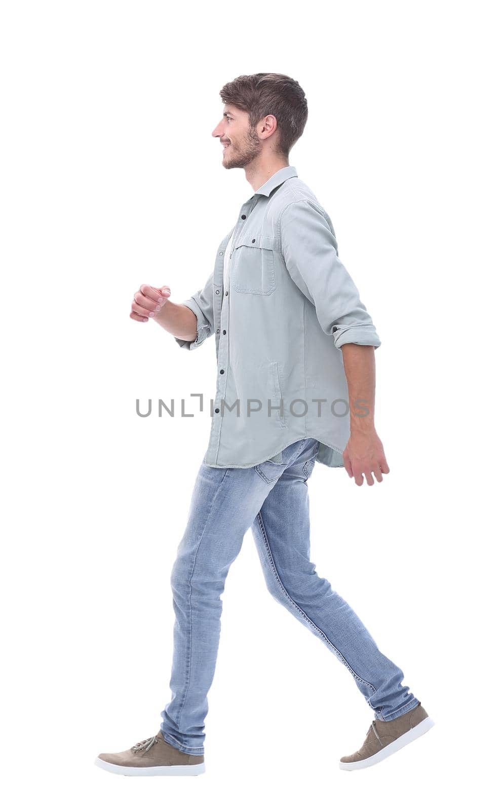 side view. a smiling young man steps forward.isolated on white background