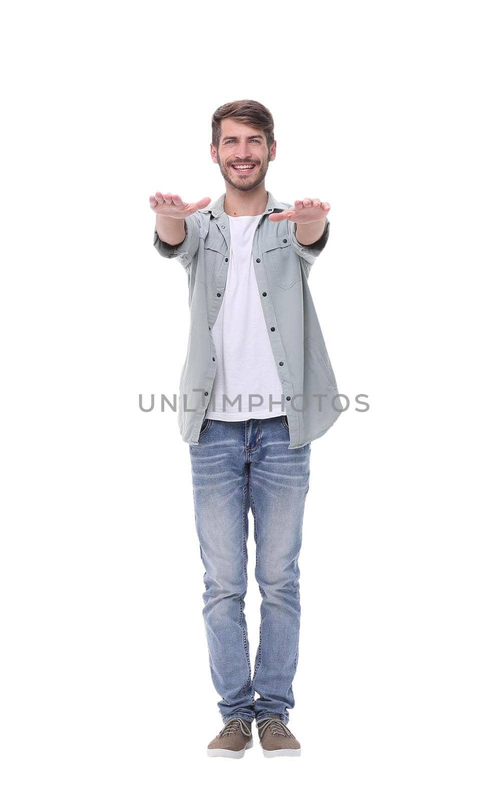 in full growth.the young man holding out his hands forward .isolated on white background