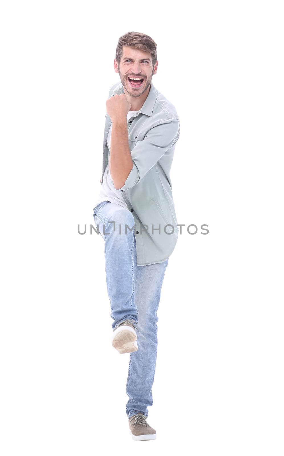 full-length. a happy young man steps forward.isolated on white background