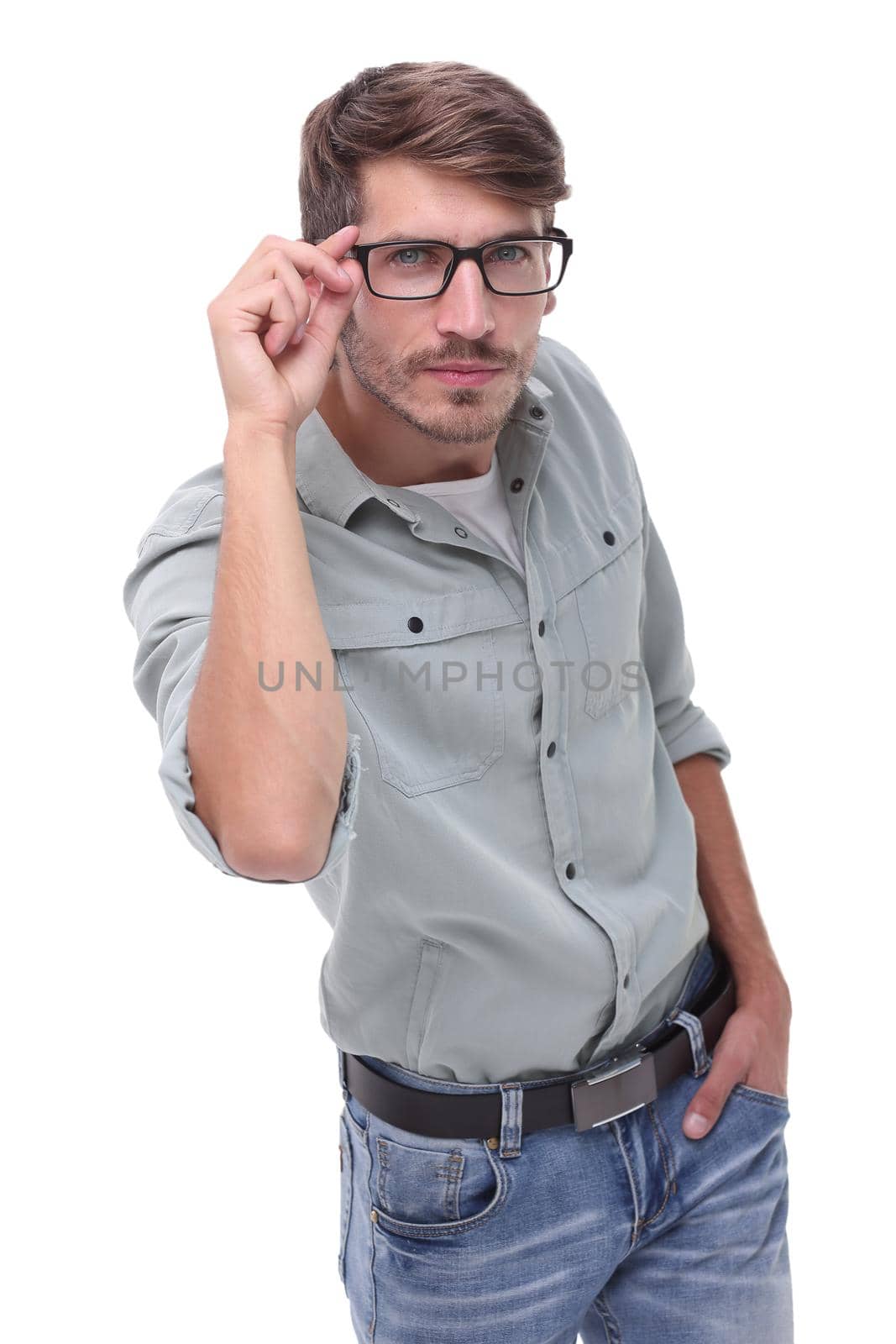 in full growth. a young man looking through his glasses .isolated on white background