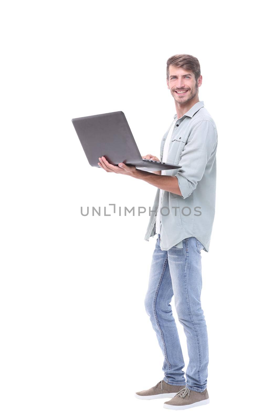 in full growth.successful young man with a laptop .isolated on white background