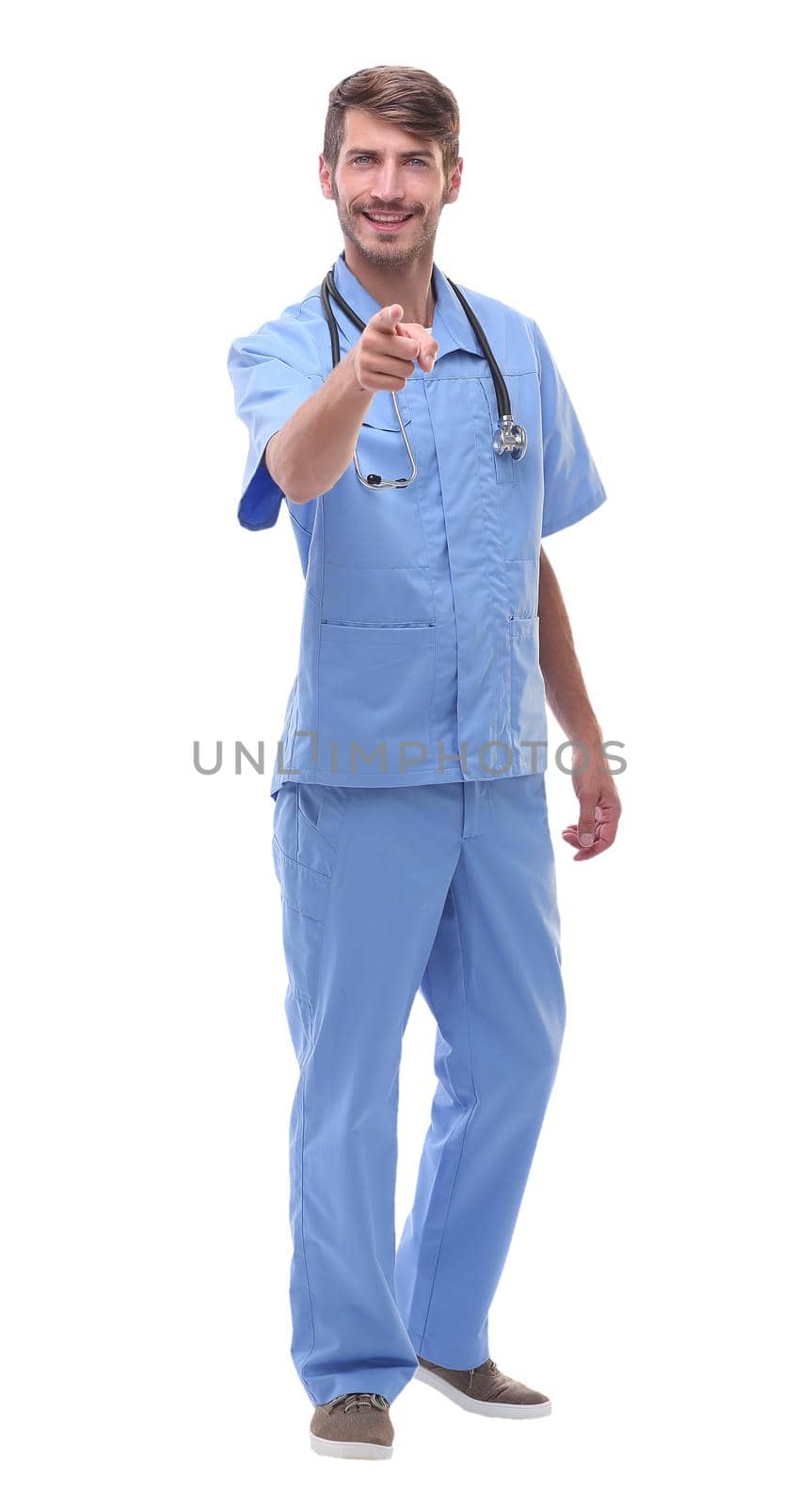 in full growth.a medical doctor with a stethoscope pointing at you.isolated on white background