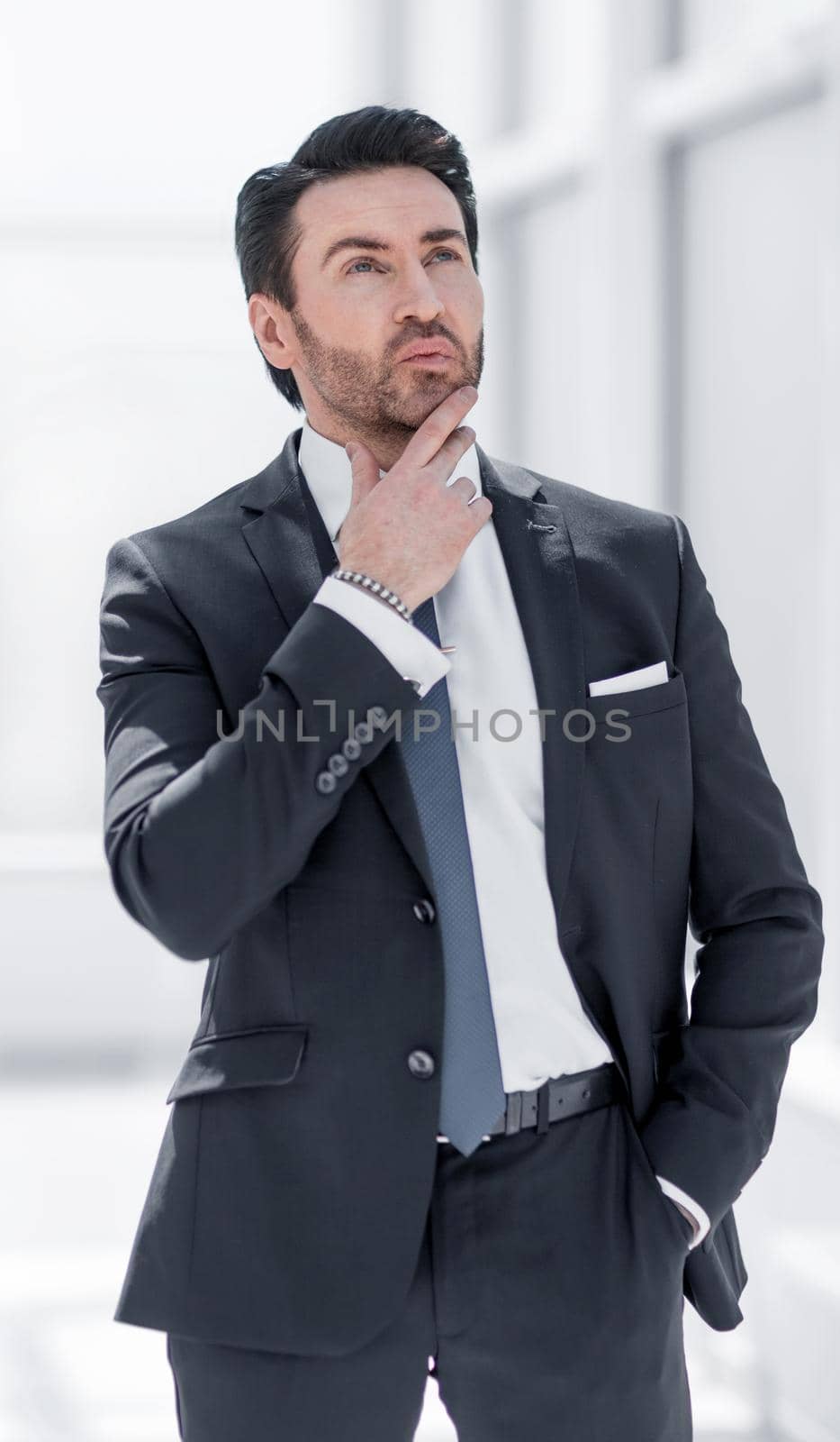 puzzled businessman looking at copy space by asdf