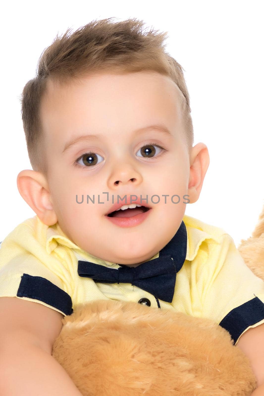 Portrait of a beautiful little boy close-up in the studio on a white background. Concept Happy childhood, family and people. Isolated.