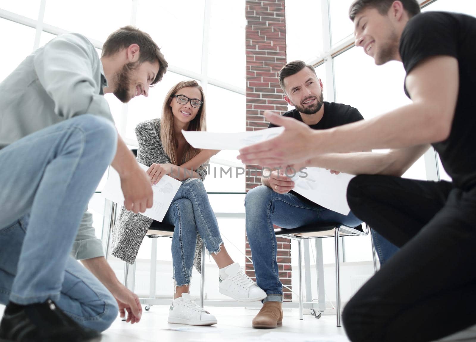 Business people sitting in office working with document having discussion.