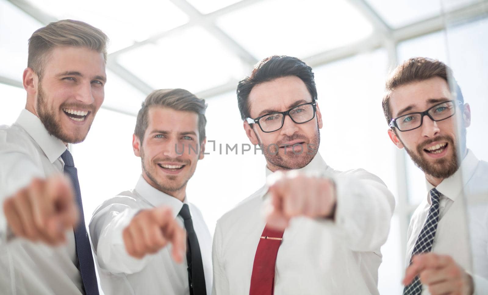 close up.confident business team pointing to you.the concept of choice