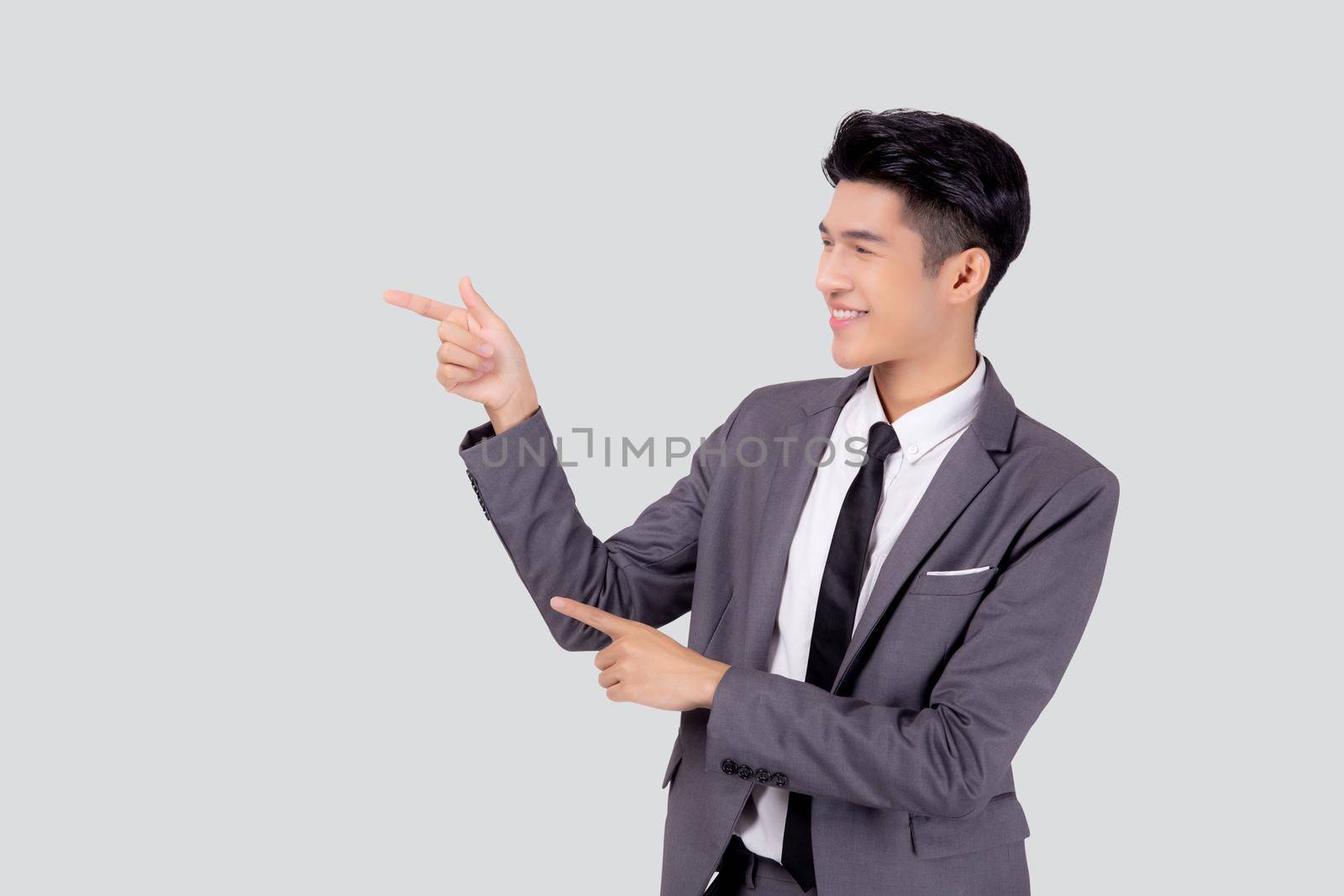 Portrait young asian business man pointing and presenting isolated on white background, advertising and marketing, executive and manager, male confident showing success, expression and emotion. by nnudoo