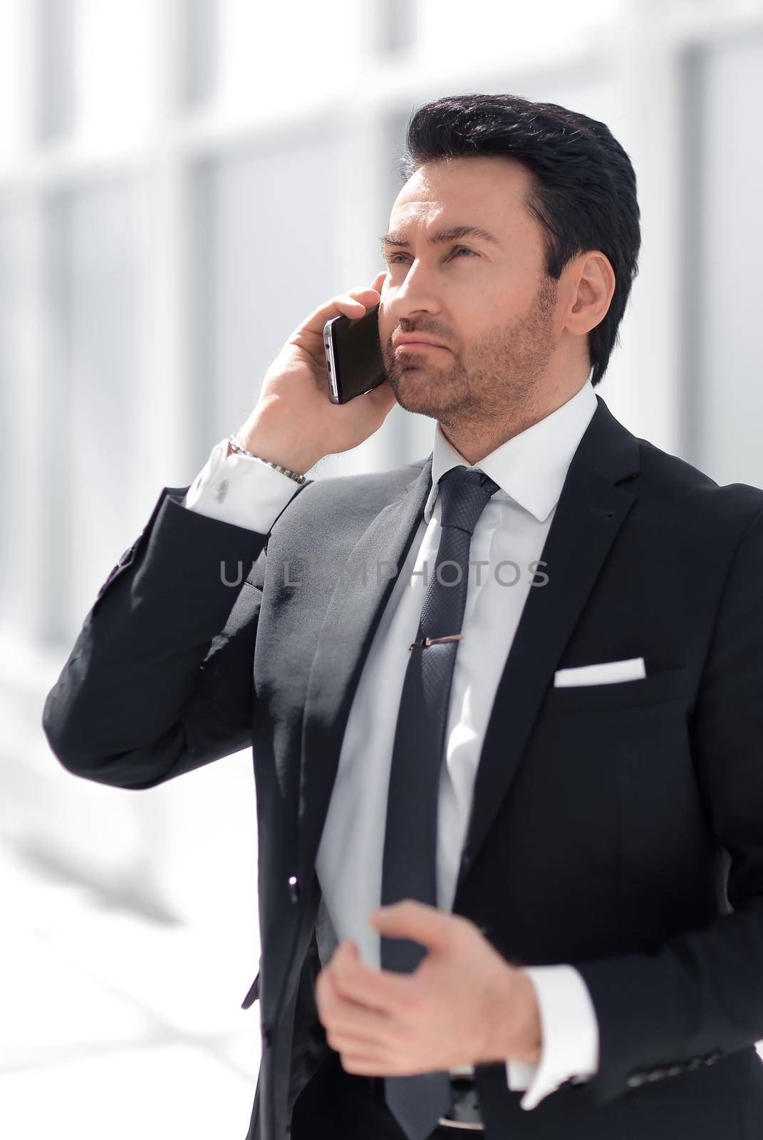 responsible businessman talking on a mobile phone by asdf