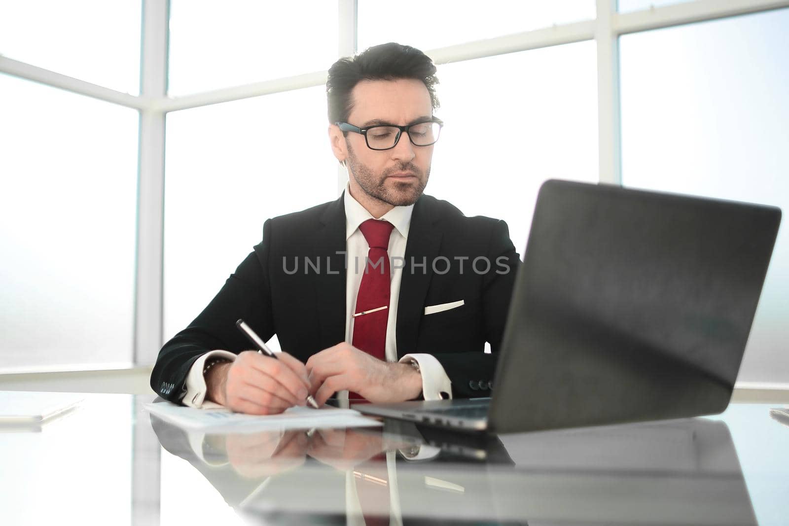 close up.businessman sitting at his Desk by asdf