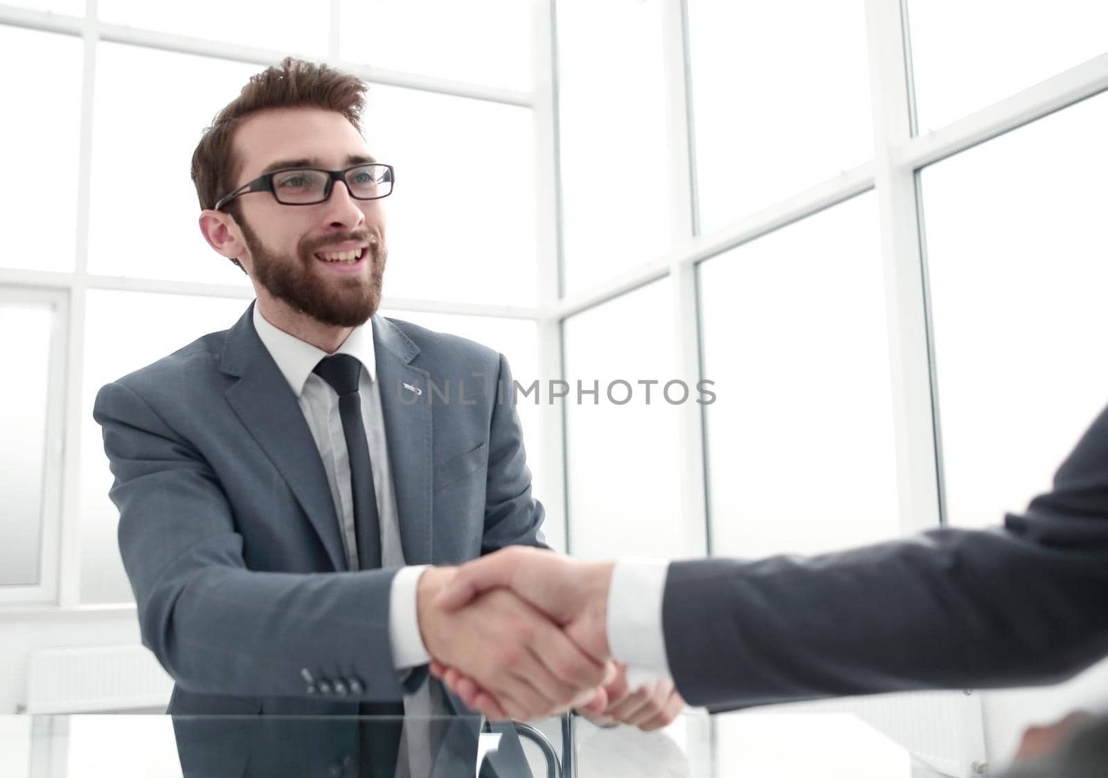 handshake business partners over the table in the office.concept of partnership