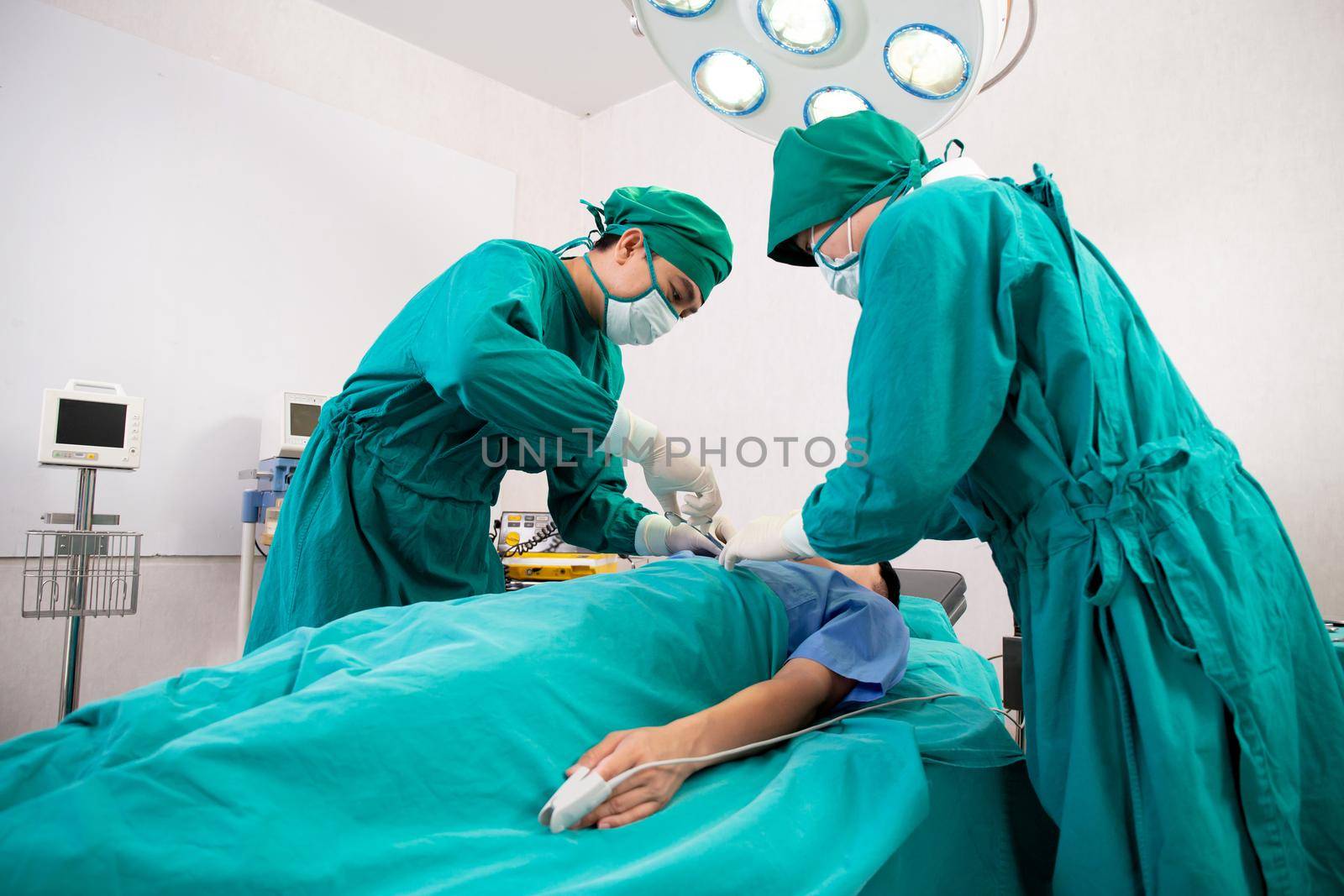 Group of team doctor and surgeon doing surgery with patient in the operation at hospital, medical and emergency, specialist and assistant rescue patient with expertise, surgical and health. by nnudoo