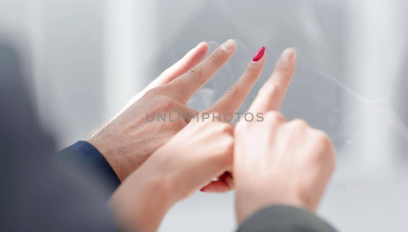 close up. business team pointing at something through the glass .business concept