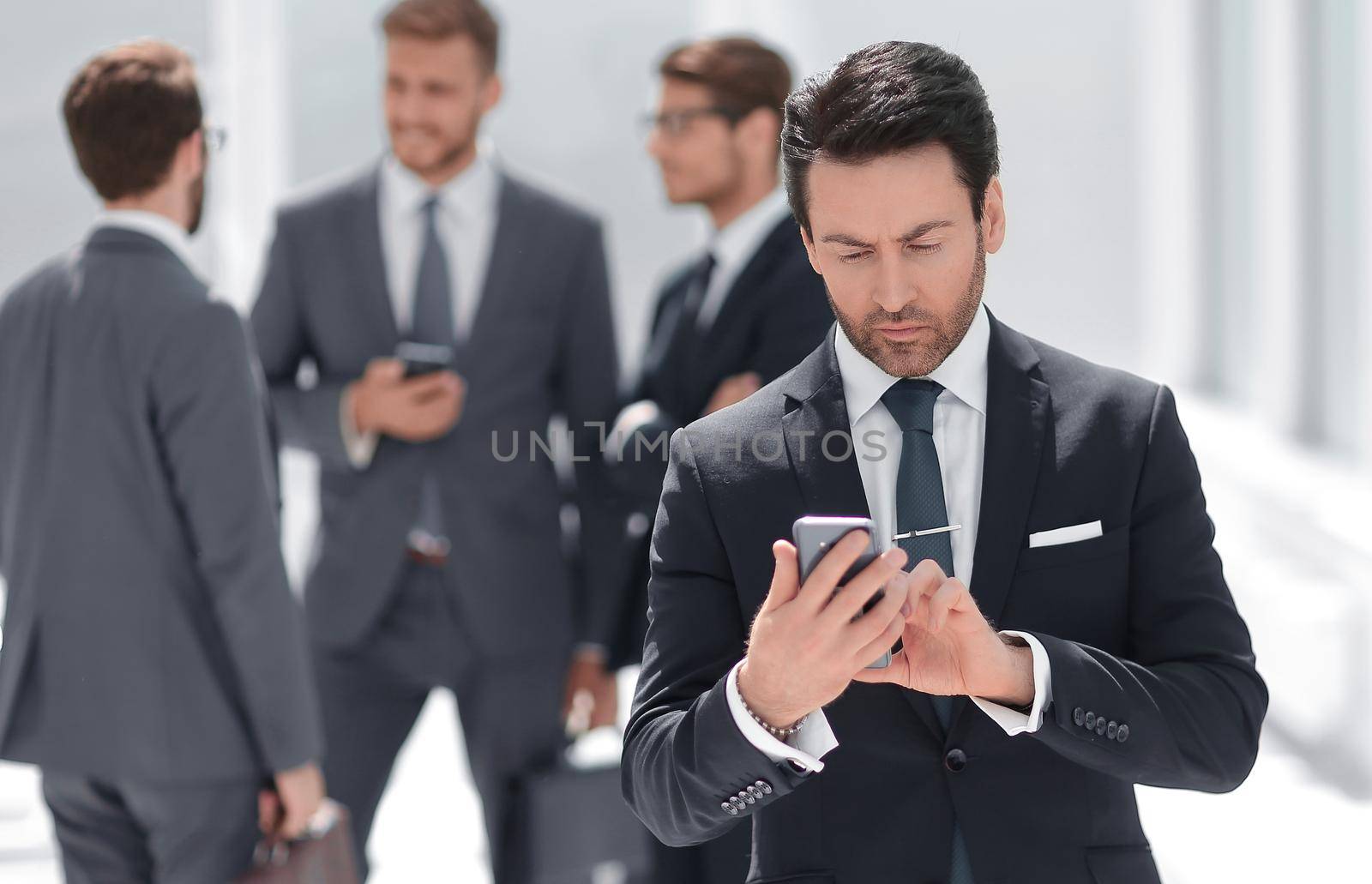 businessman reading text on smartphone by asdf