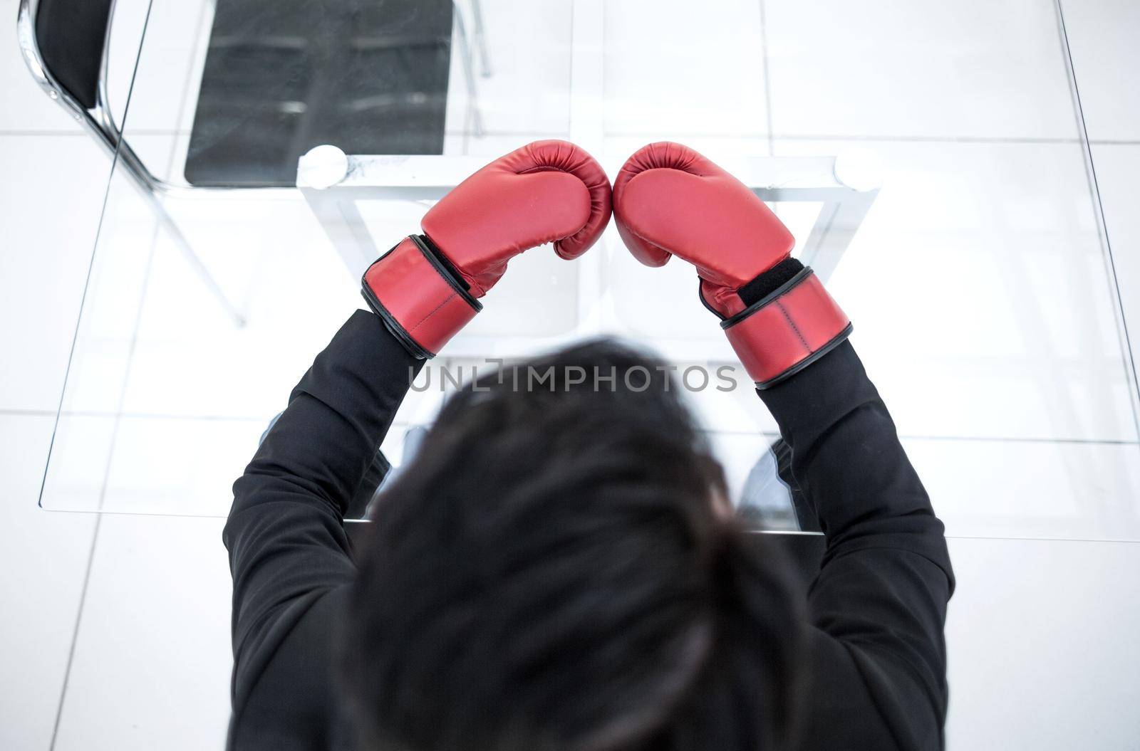 close up. businessman in red gloves sitting at a glass table.business concept