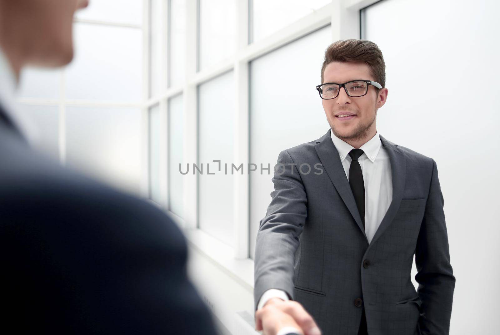 Manager greets the client with a handshake.concept of partnership