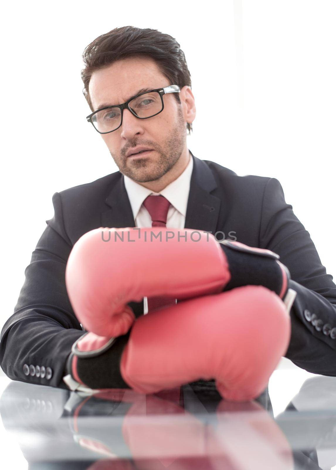 close up.confident businessman Boxing gloves sitting at his Desk .the concept of protection