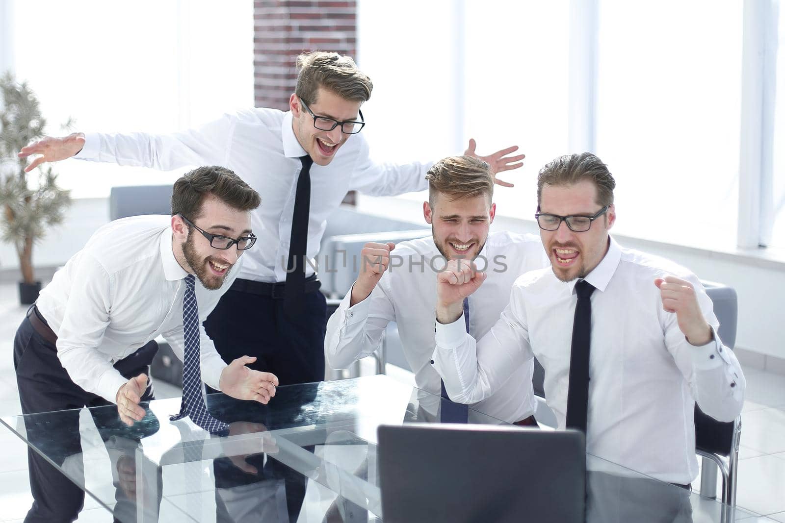 happy business team looking at the laptop screen .photo with copy space