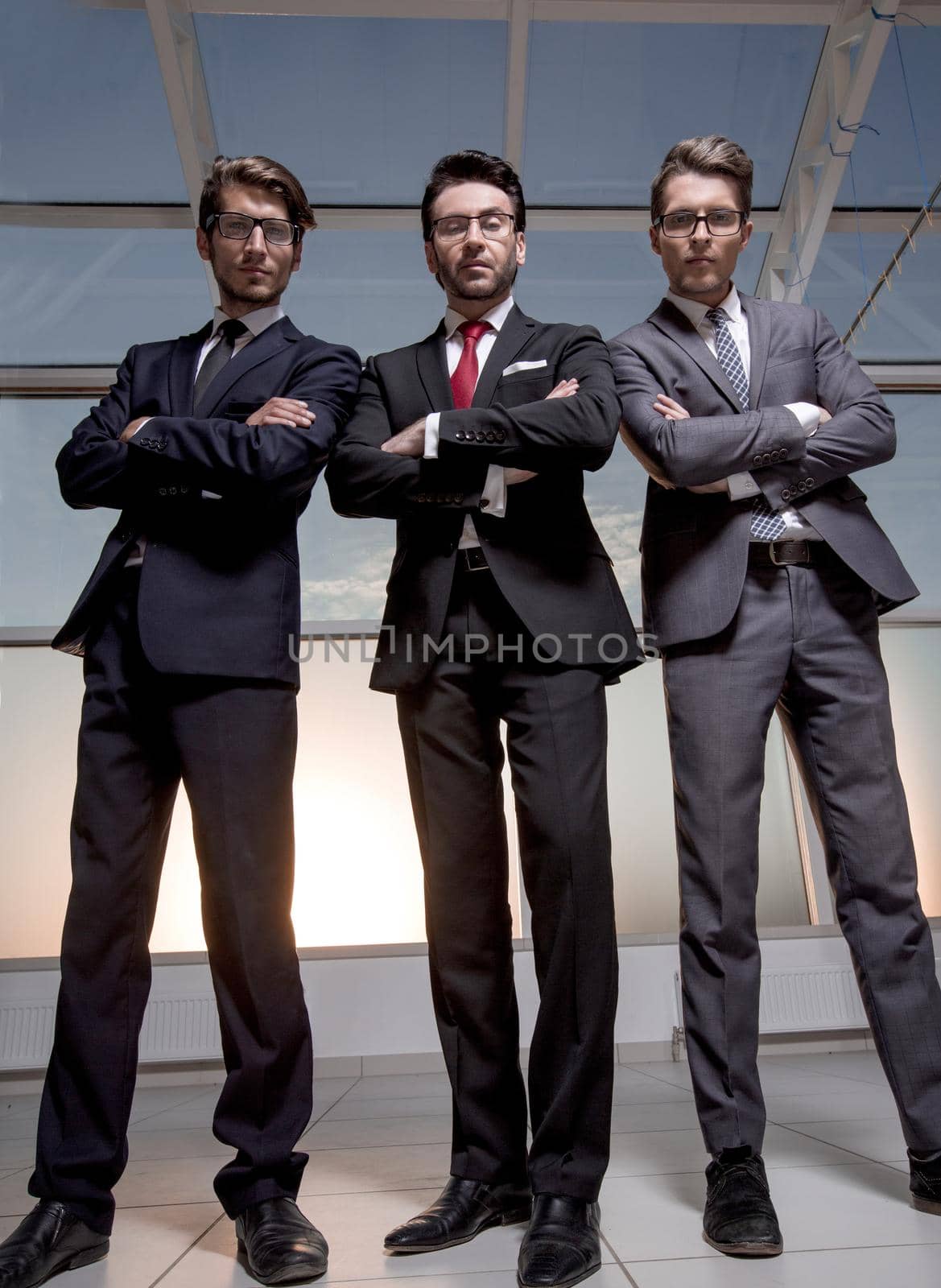 in full growth.three confident businessmen look forward by asdf