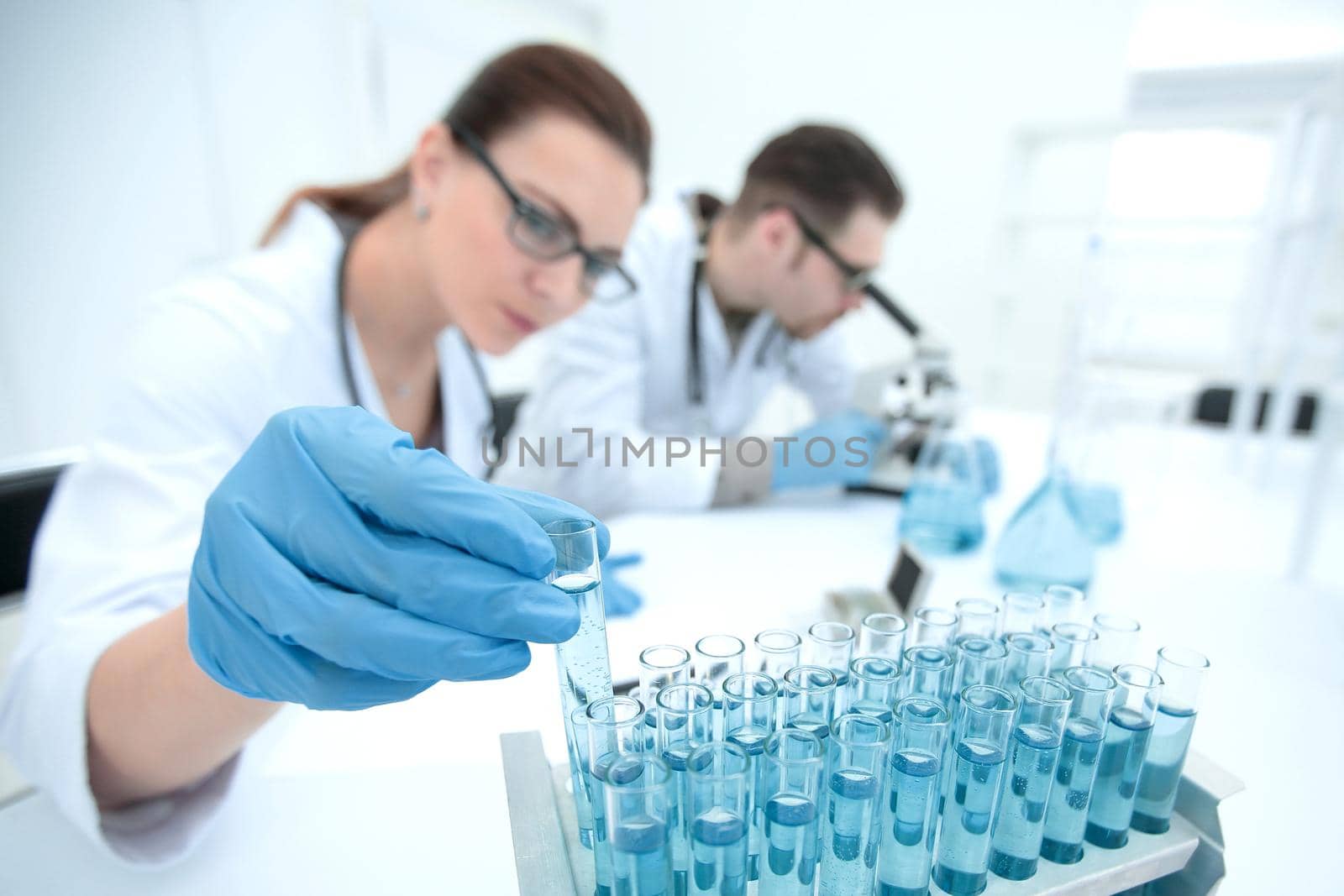 female researcher and her senior supervisor are doing investigations with test tubes.photo with copy space