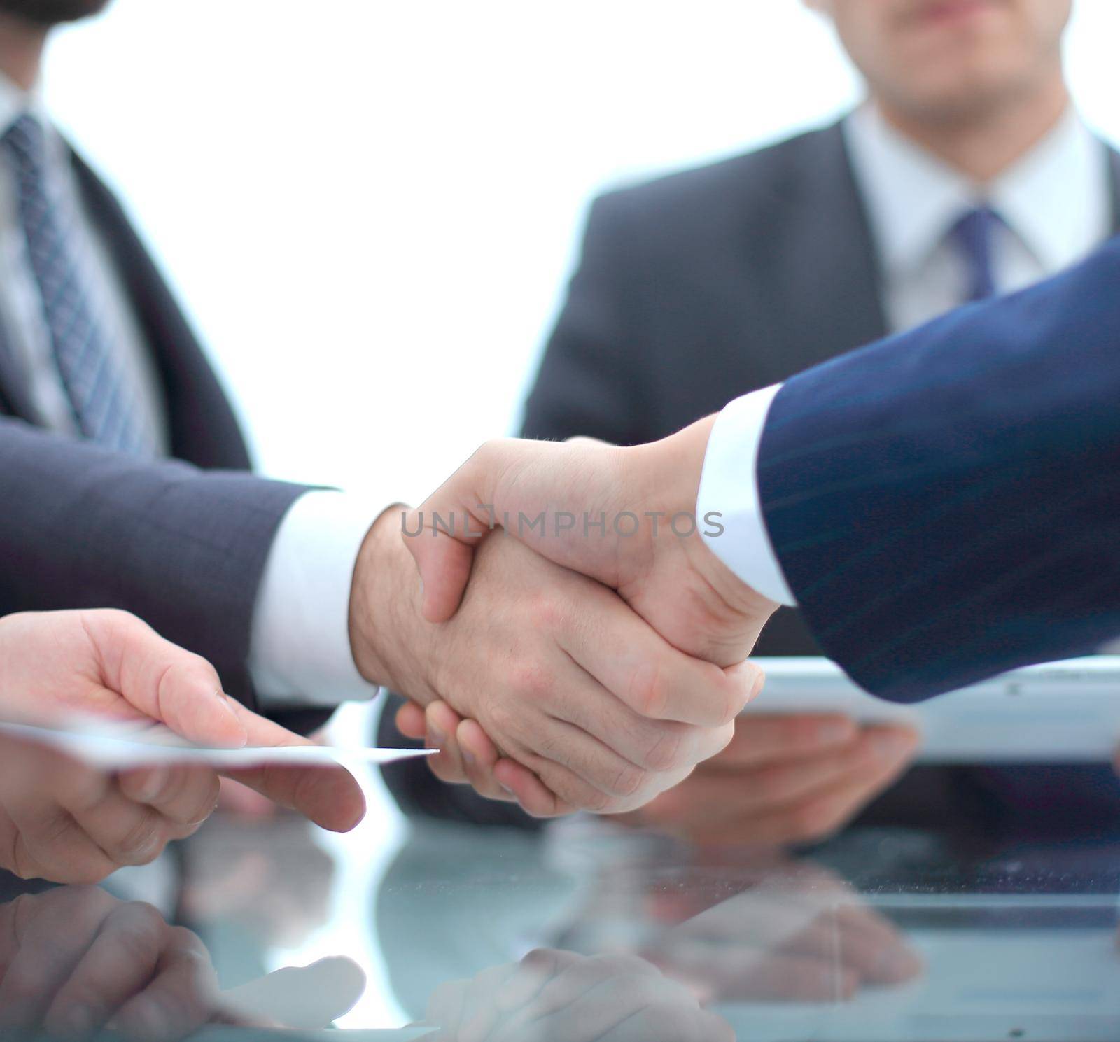 handshake business colleagues in office