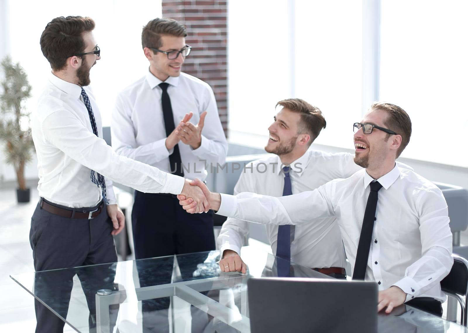 business colleagues shaking hands in the workplace.photo with copy space