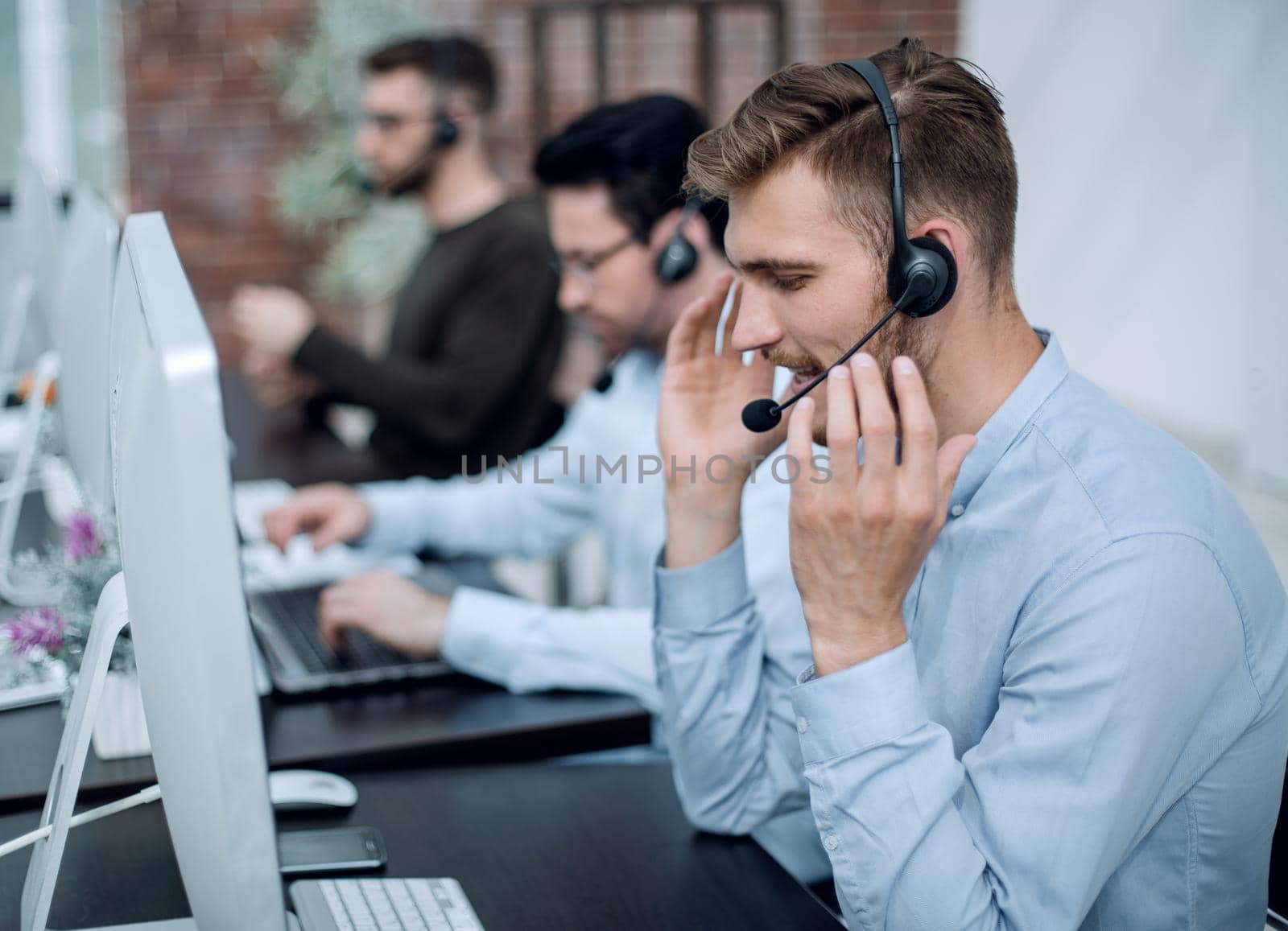 employees with a headset in the workplace in the business center.business concept