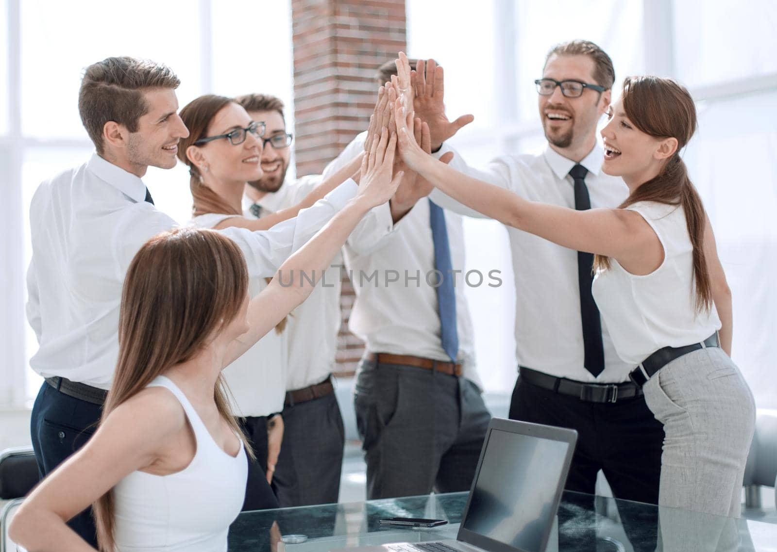 young business team giving each other high five.the concept of teamwork