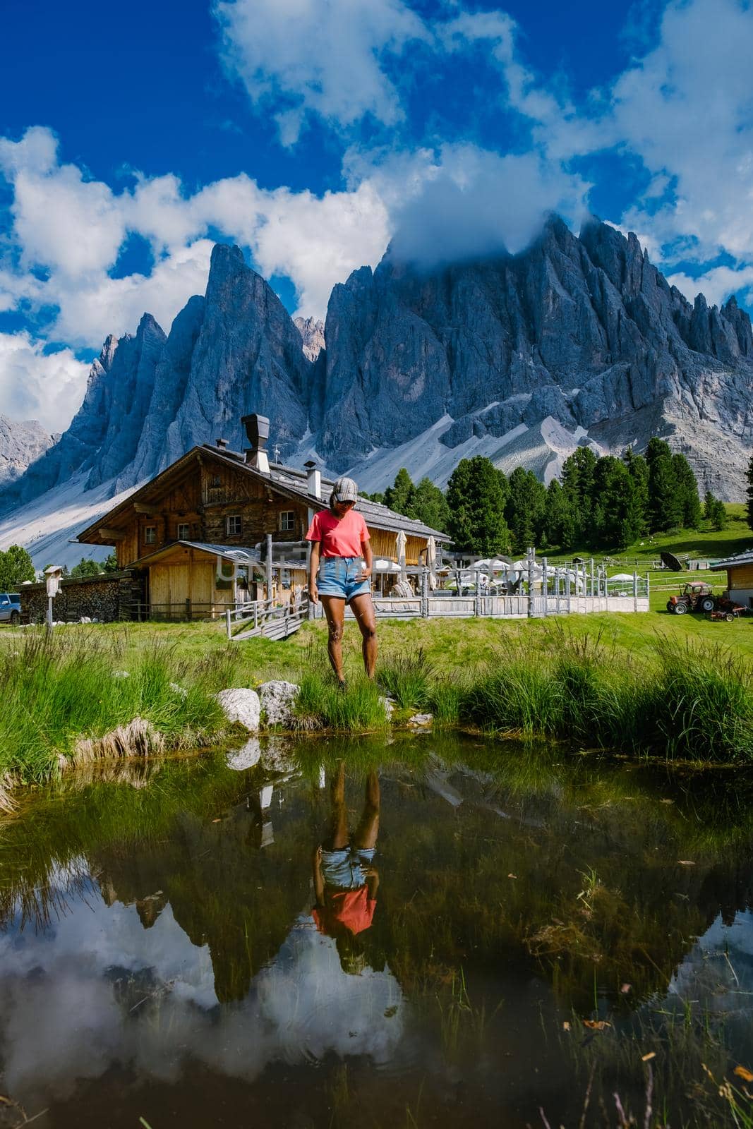 Geisler Alm, Dolomites Italy, hiking in the mountains of Val Di Funes in Italian Dolomites,Nature Park Geisler-Puez with Geisler Alm in South Tyrol. Italy Europe, woman hiking in moutains summer