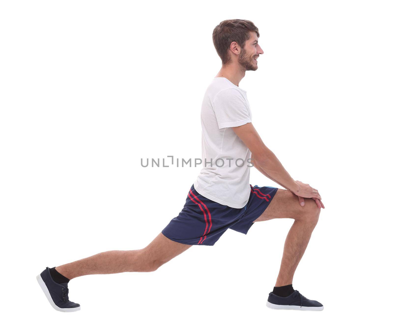 Full length.active male performs squats with straight arms. isolated on white background