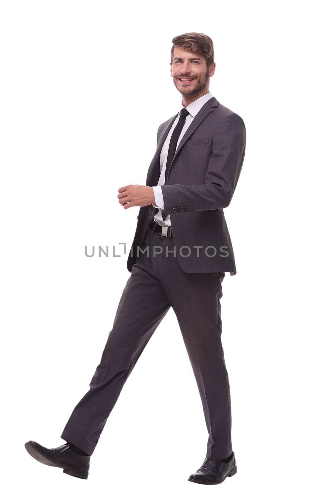 full growth. the modern businessman is stepping forward.isolated on white background