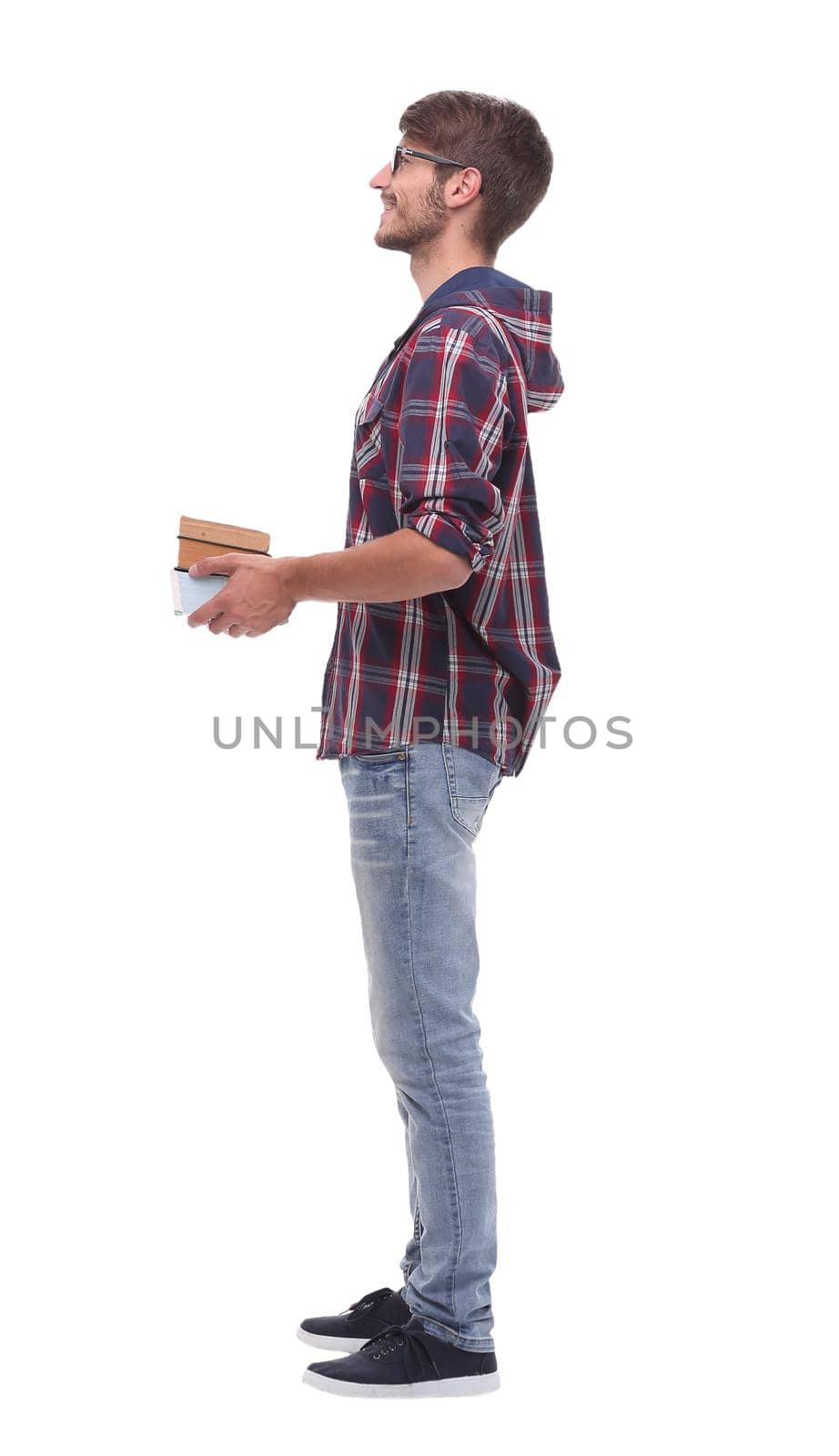 side view. smiling male student with books.isolated on white background.