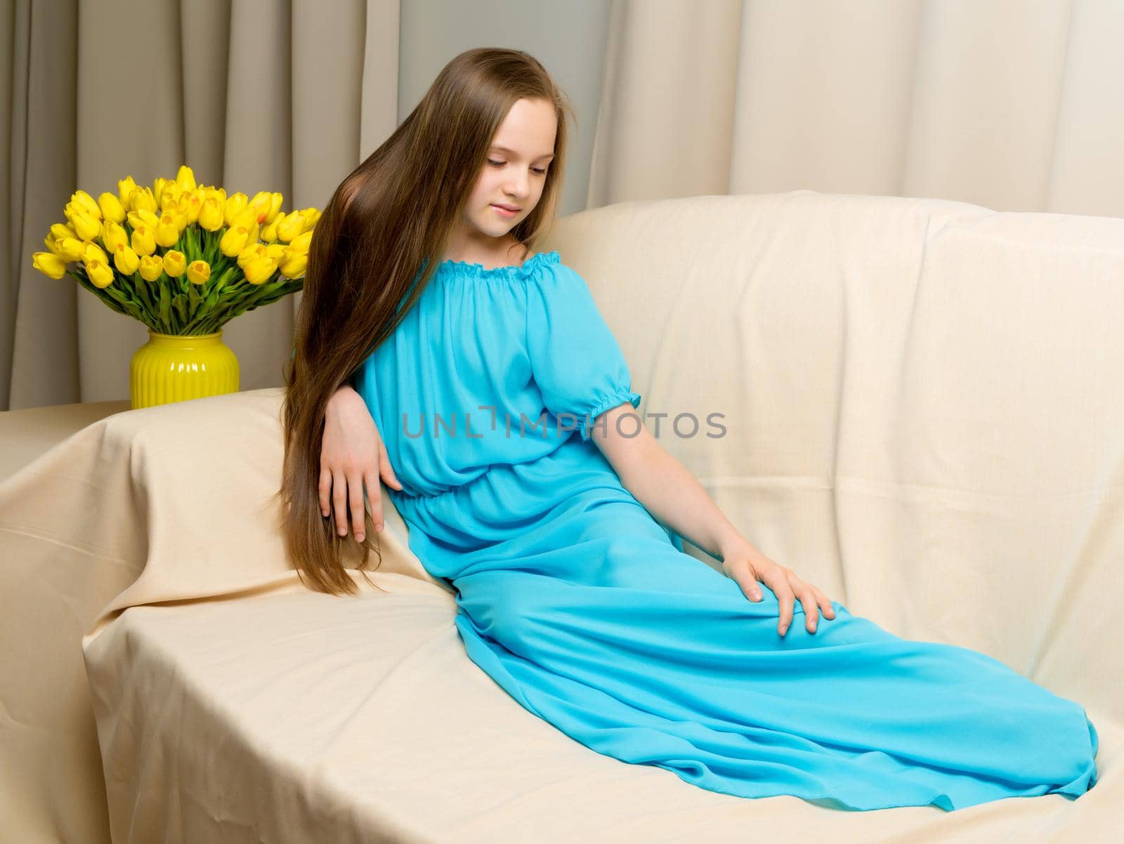 Lovely school girl with long silky hair with a bouquet of tulips by kolesnikov_studio