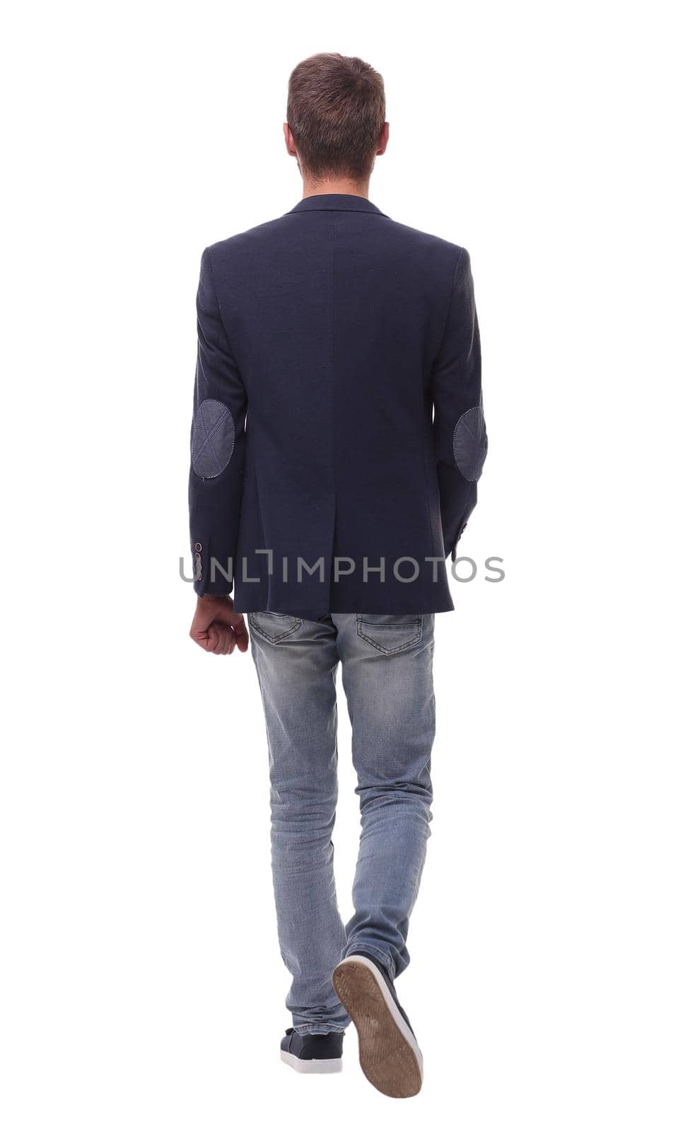 rear view. modern business man stepping forward .isolated on white background