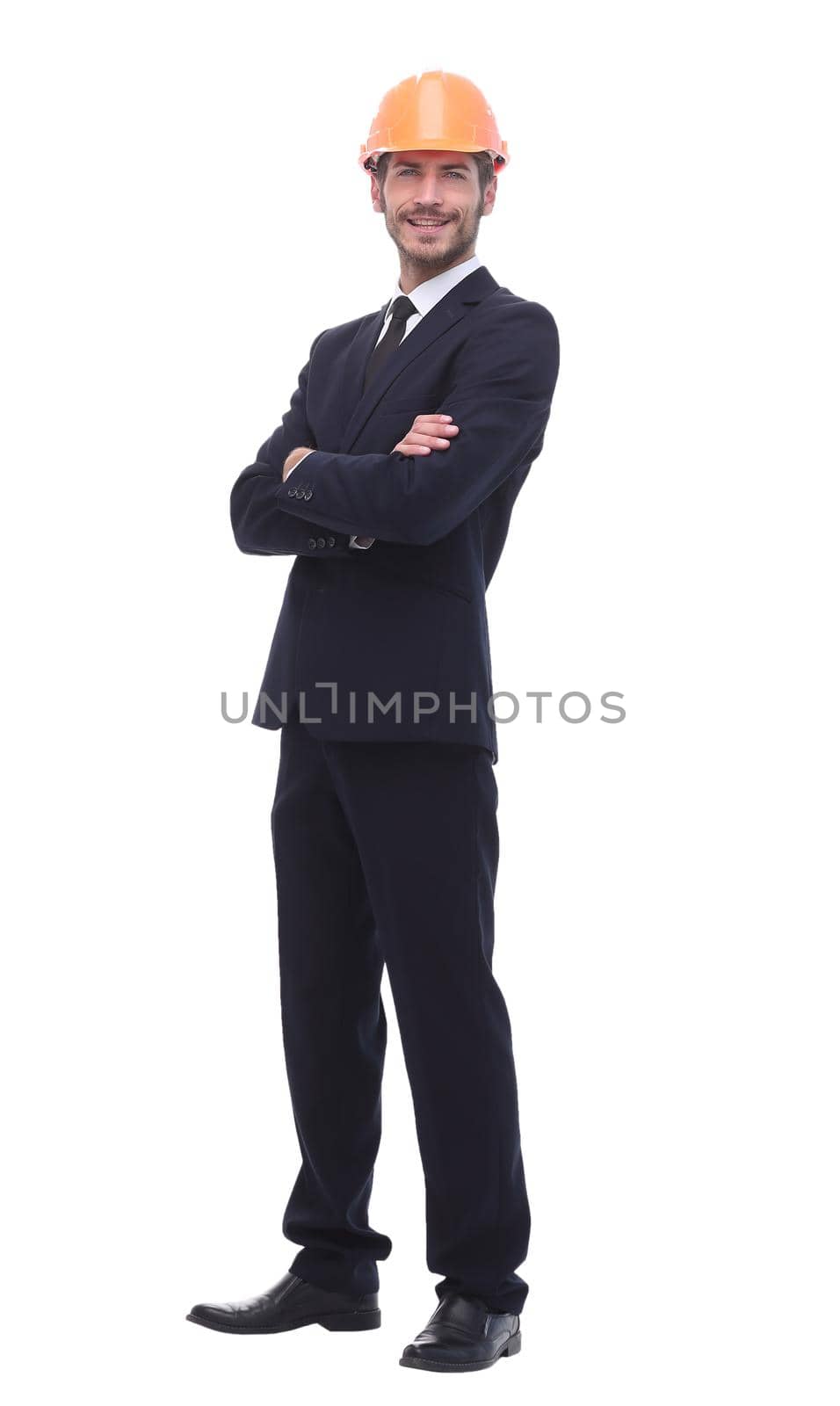 in full growth. a serious businessman in a protective helmet. isolated on white background