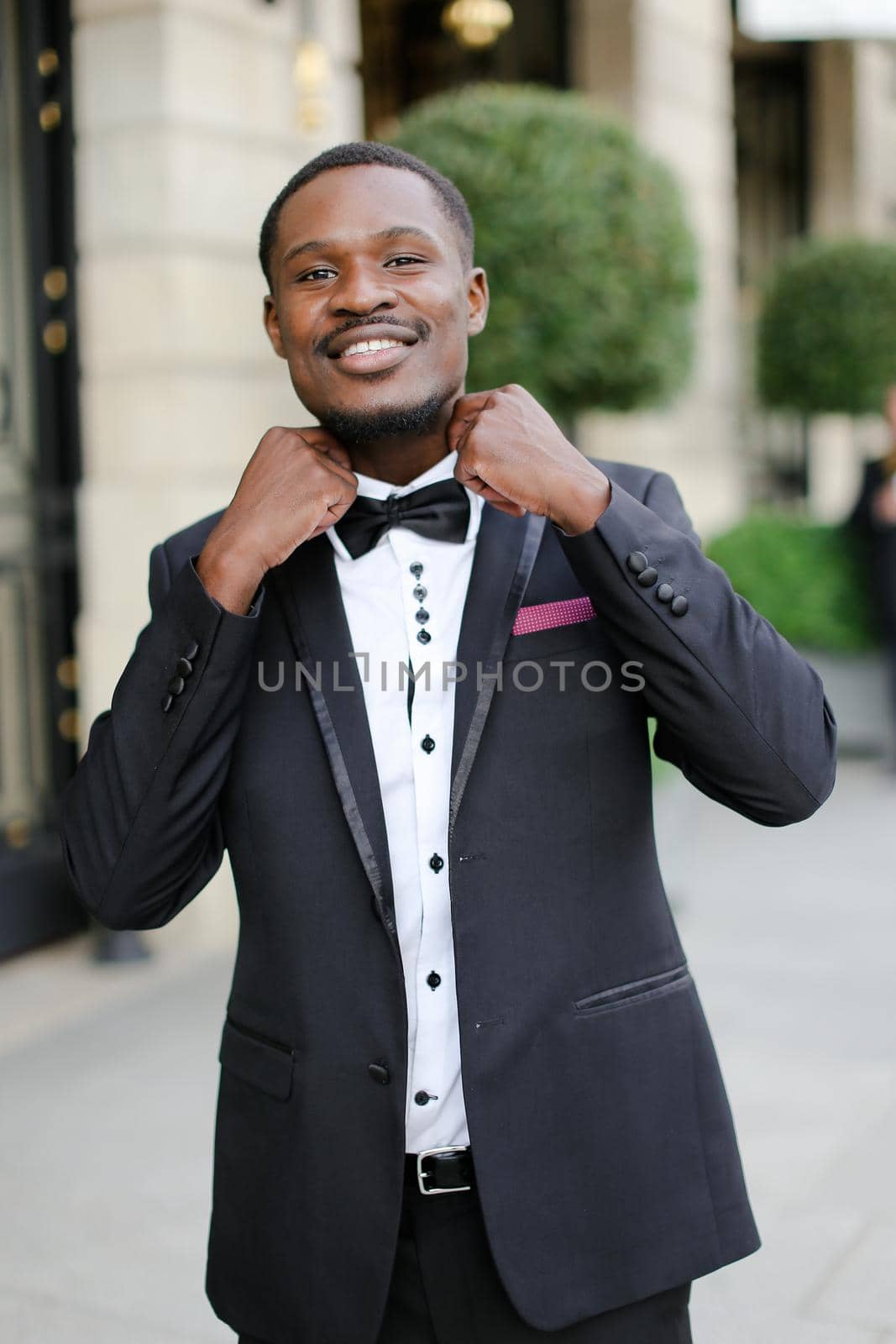 Afro american happy good looking man wearing suit and smiling. Concept of black businessman.