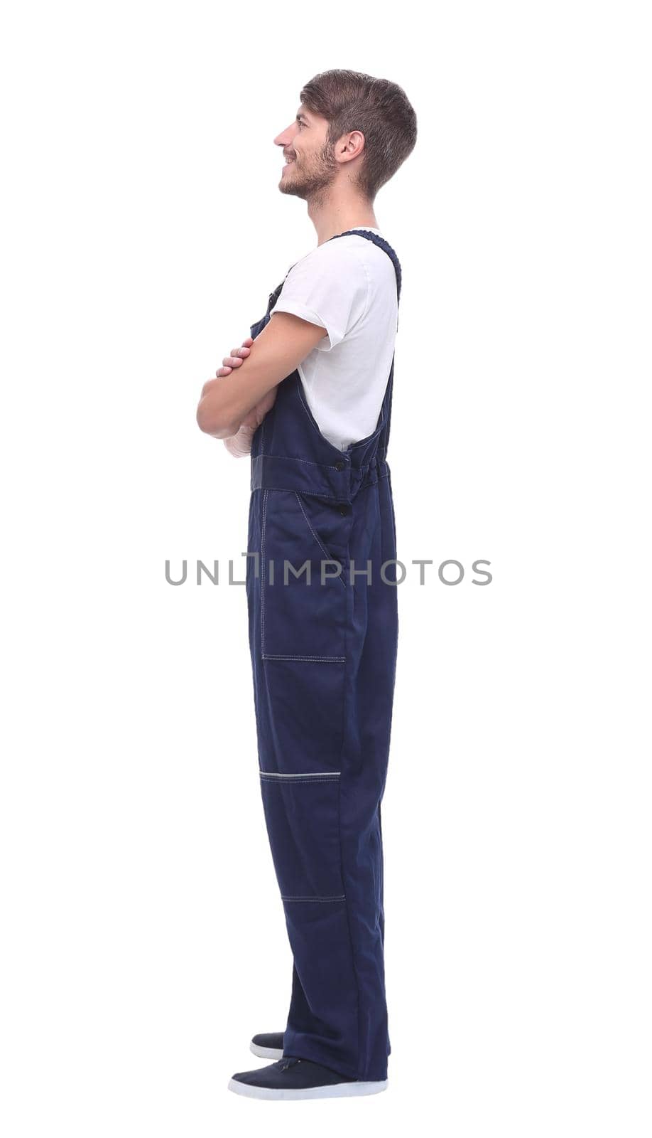 rear view.young man in blue overalls. isolated on white background