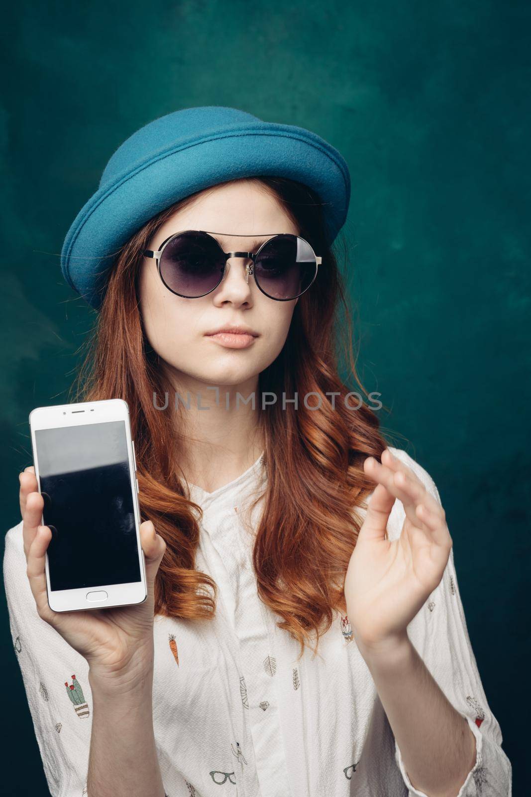 fashionable woman in blue hat with phone in hands communication technology by Vichizh