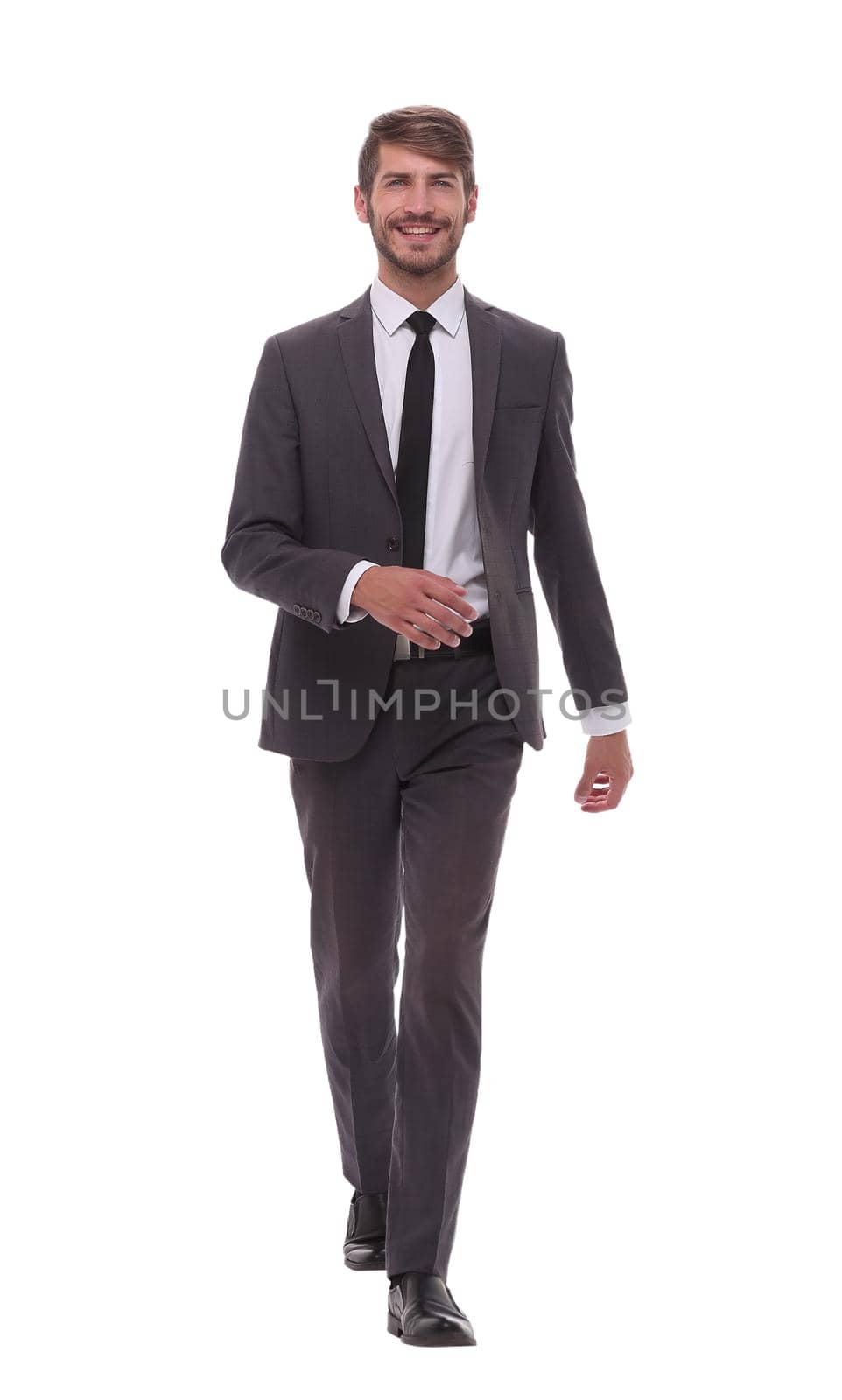 full growth. the modern businessman is stepping forward.isolated on white background