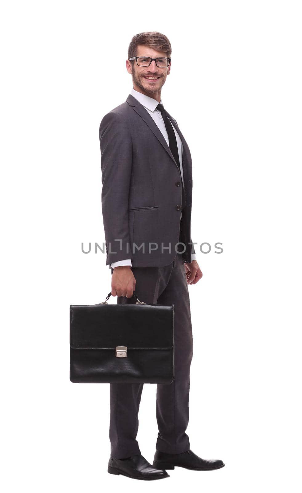 in full growth. confident businessman with leather briefcase.isolated on white background