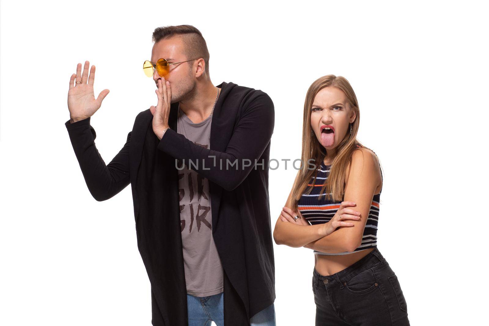 Funny young couple posing in studio. Isolated on white background. Studio shot