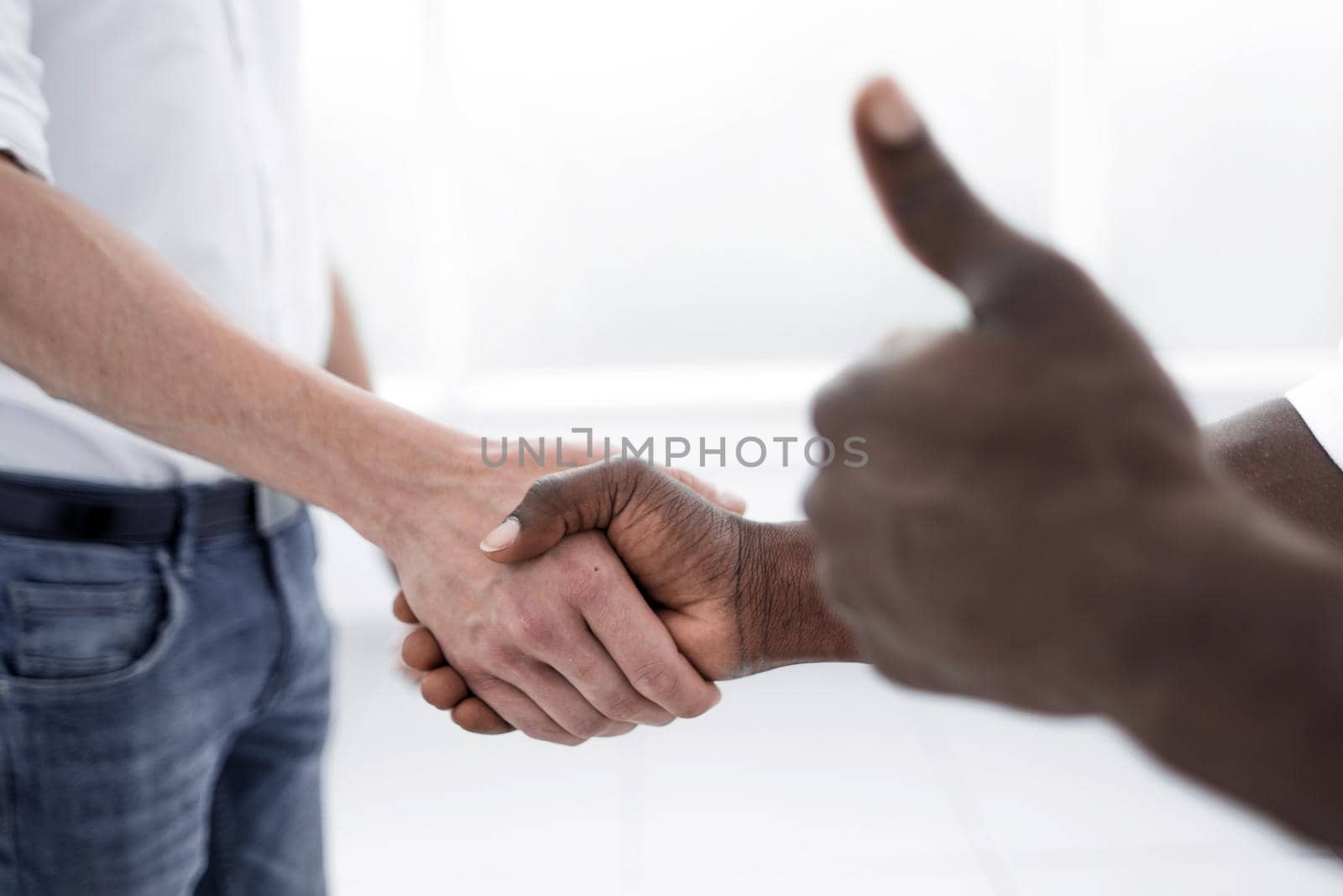 close up.business people shaking hands while standing in the office.concept of cooperation