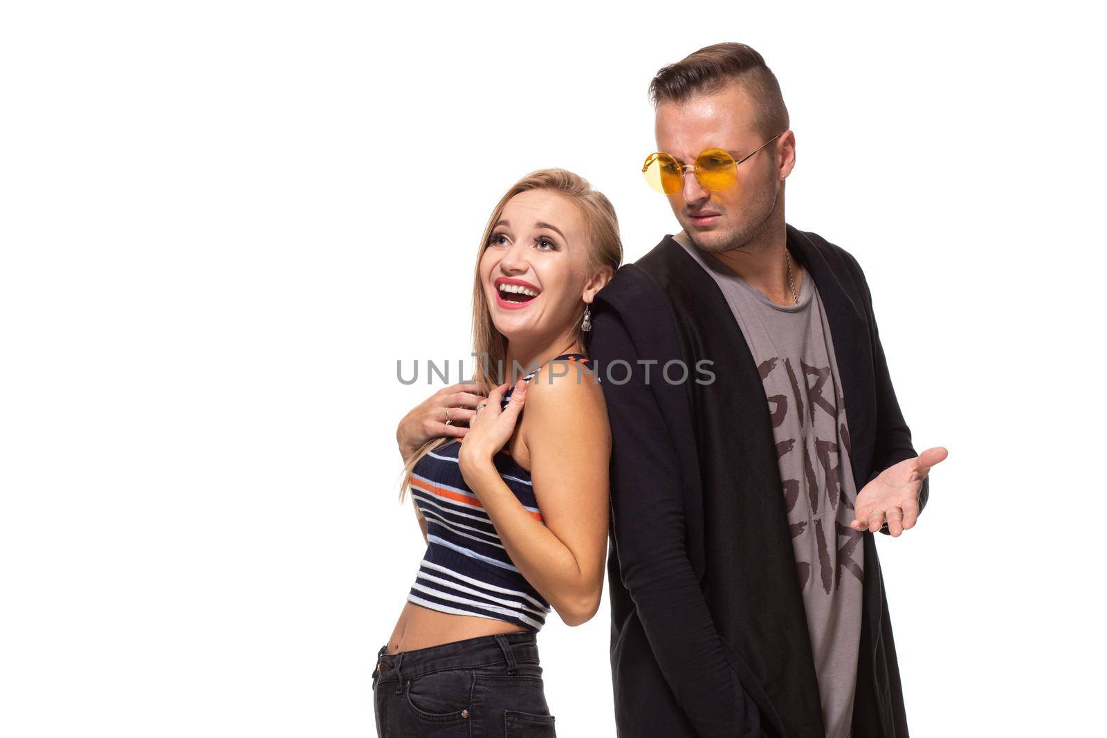 Funny young couple posing in studio. Isolated on white background. Studio shot