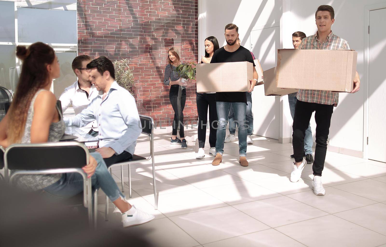 creative business team brings cardboard boxes to the new office.the concept of a startup