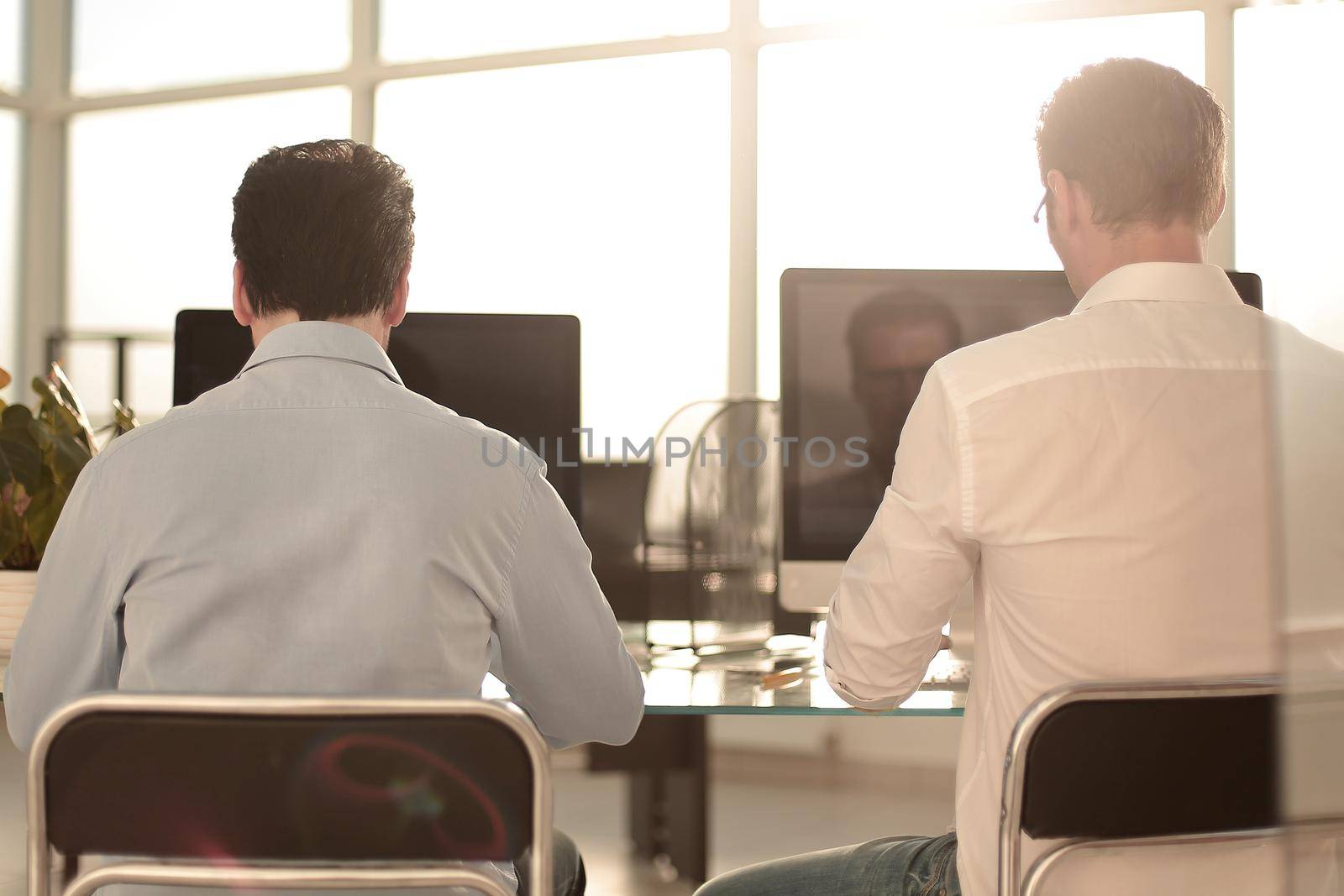 rear view.two business people working at the Desk.business concept